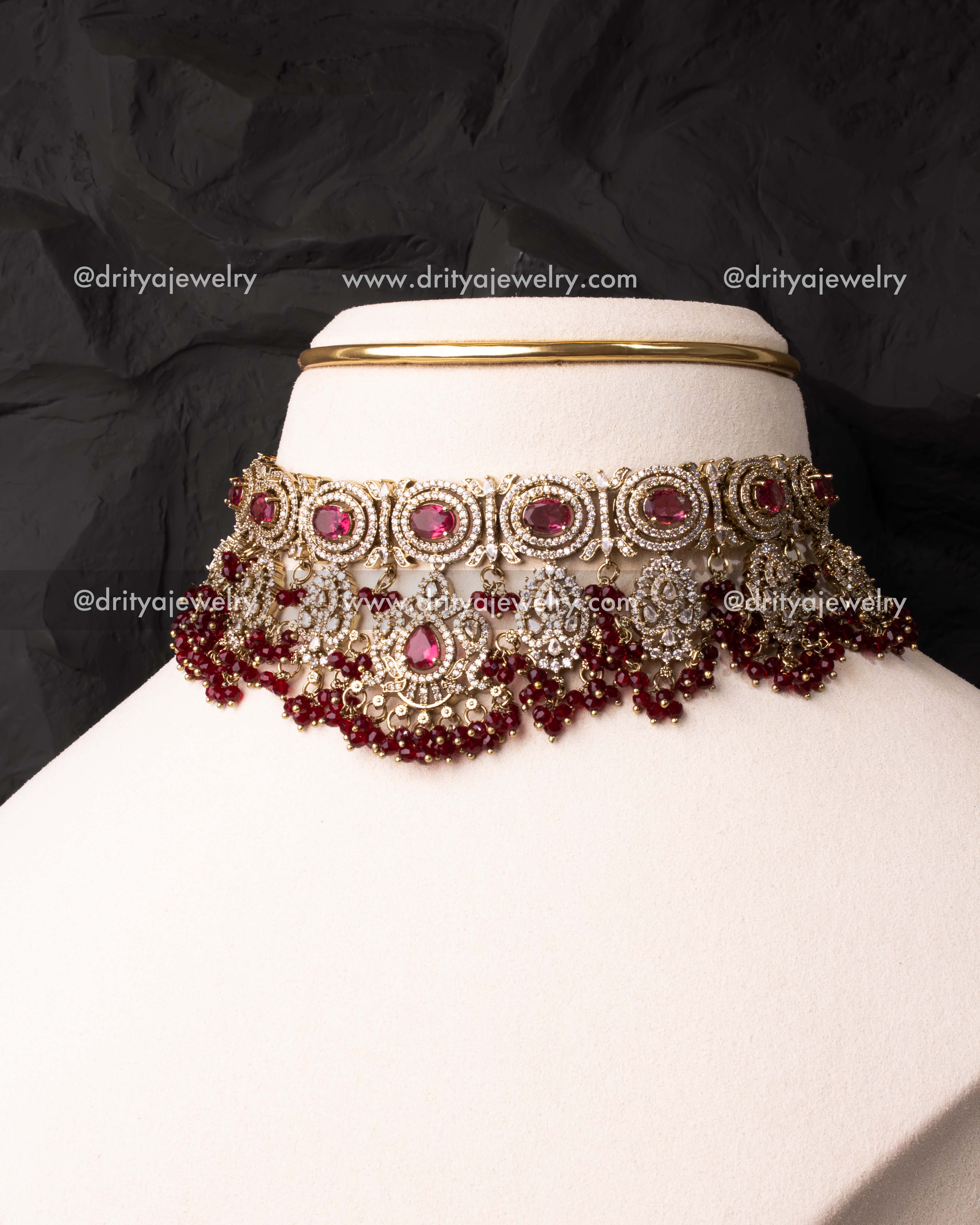 Elegant Victorian choker with ruby red stones and intricate detailing.