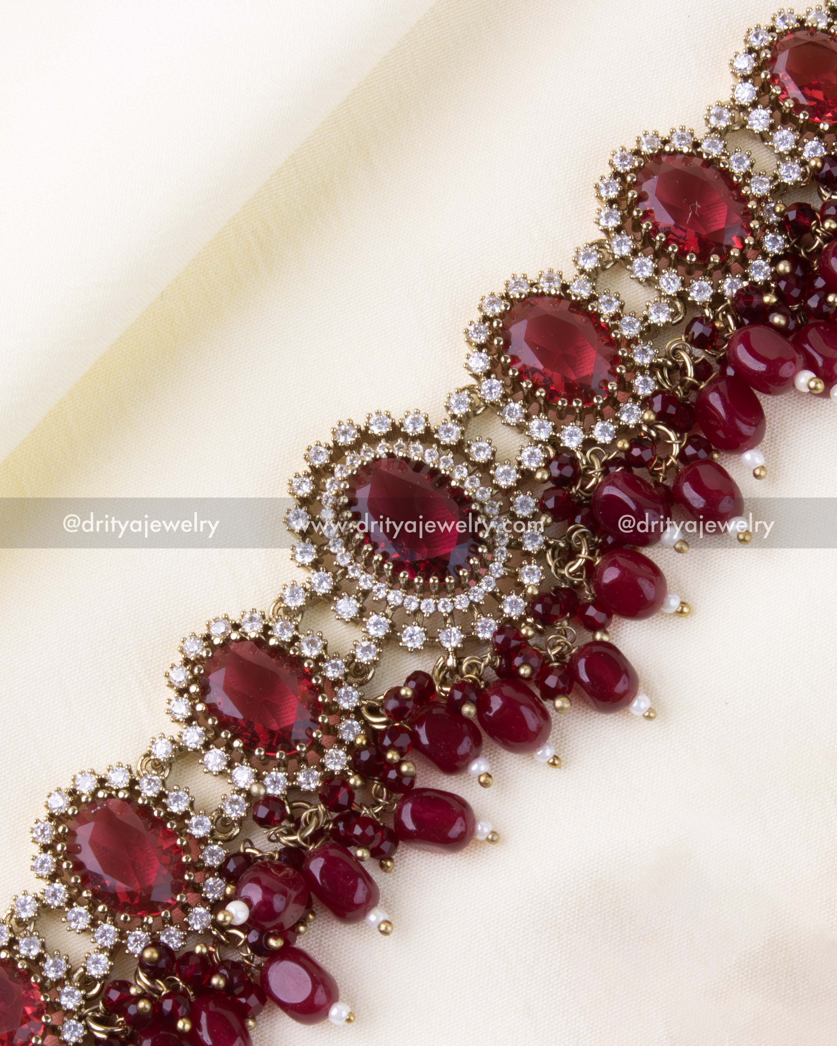 Detailed choker view featuring AD halo around ruby red stones
