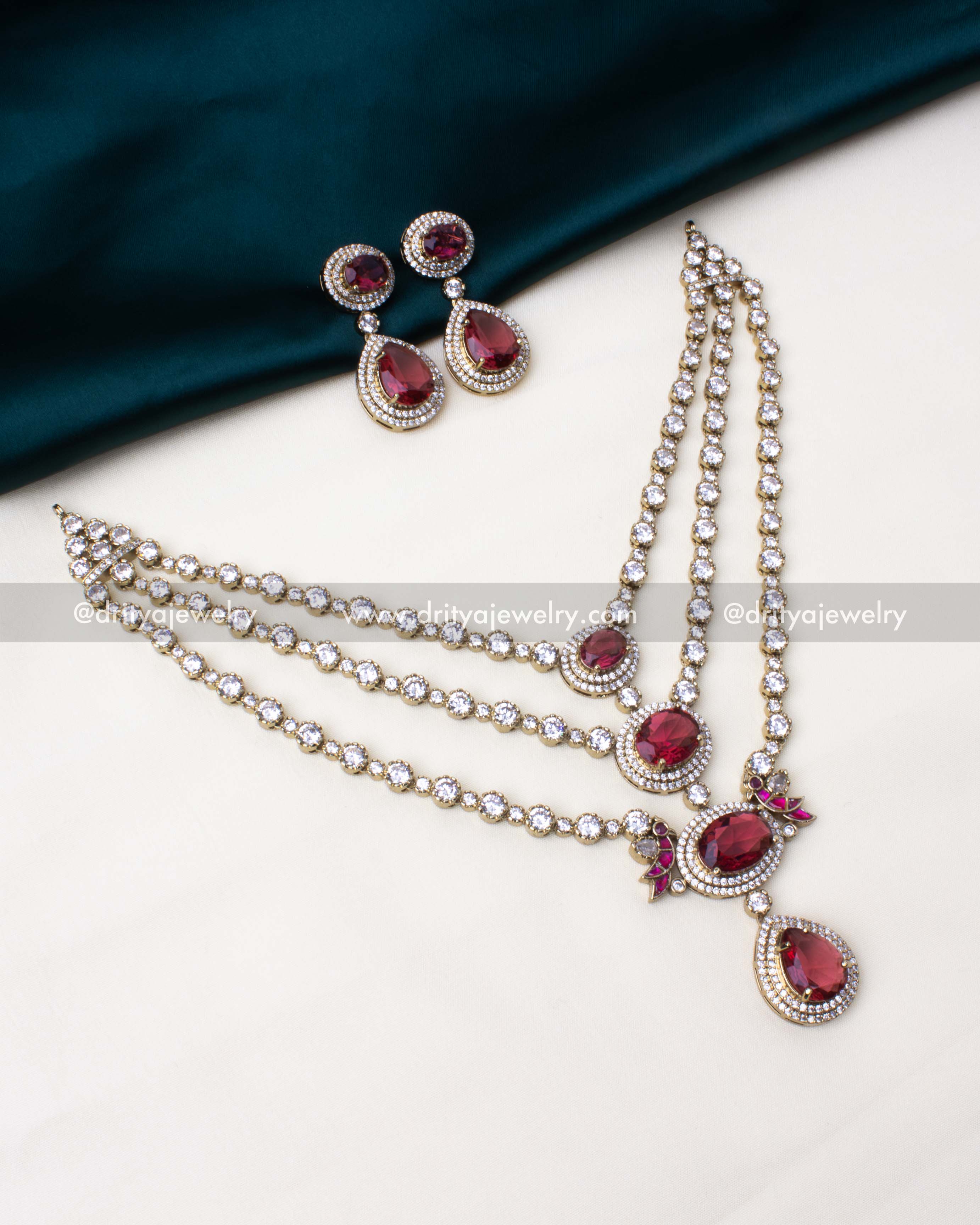 Triple-layered ruby necklace set with sparkling CZ stones, perfect for festive occasions.