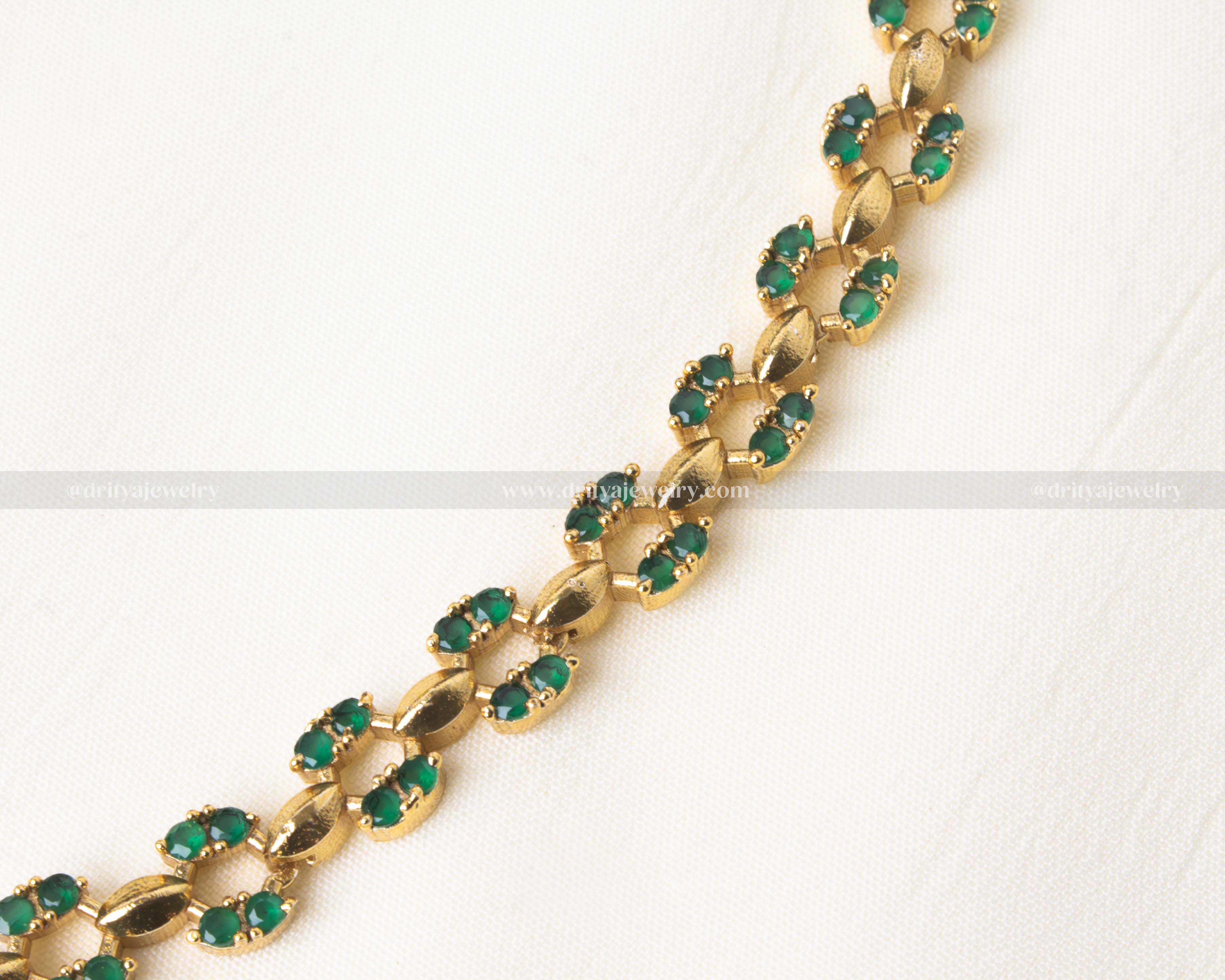 Stylish short necklace set featuring pink AD stones and a gold-tone finish.