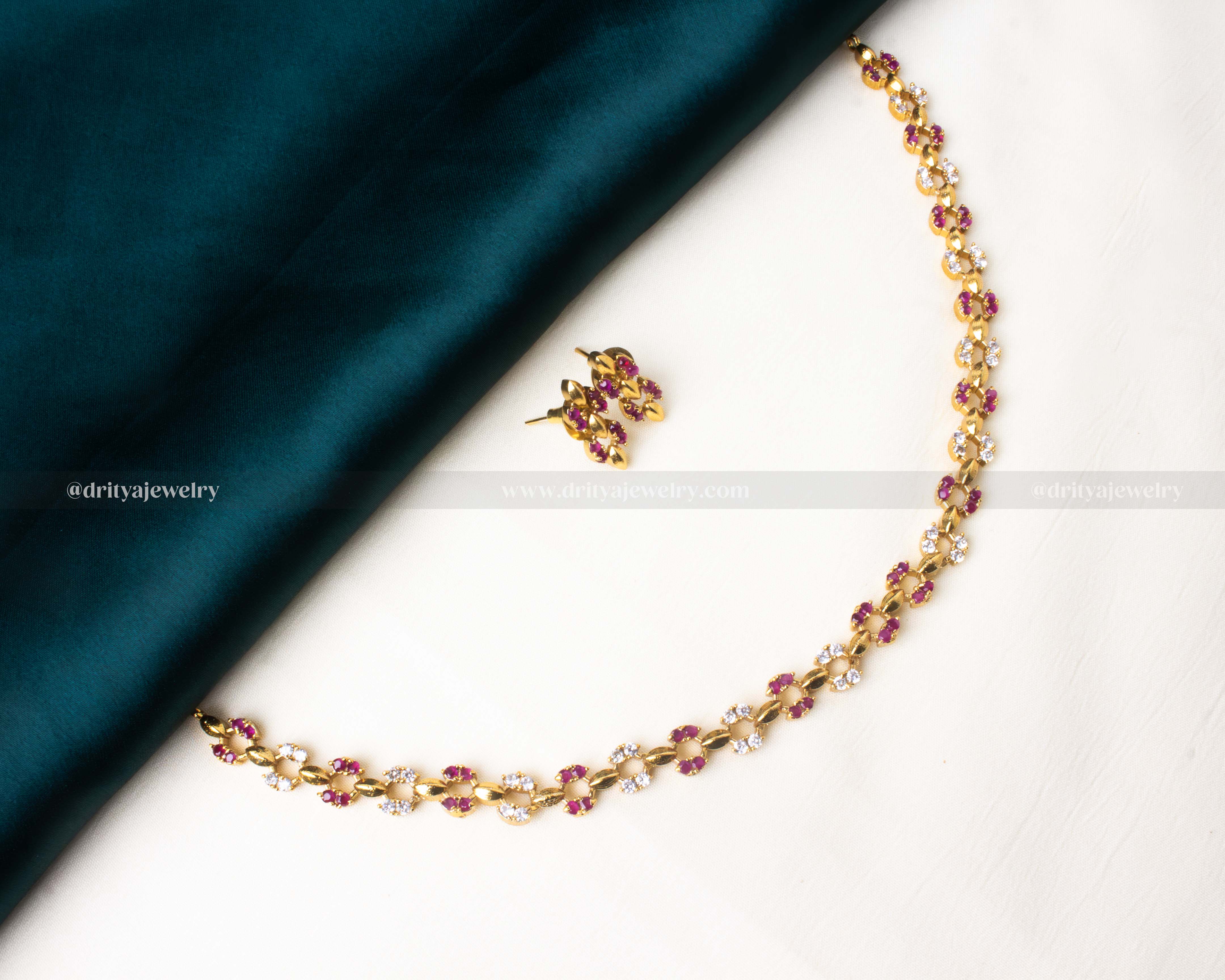 Stylish short necklace set featuring pink AD stones and a gold-tone finish.