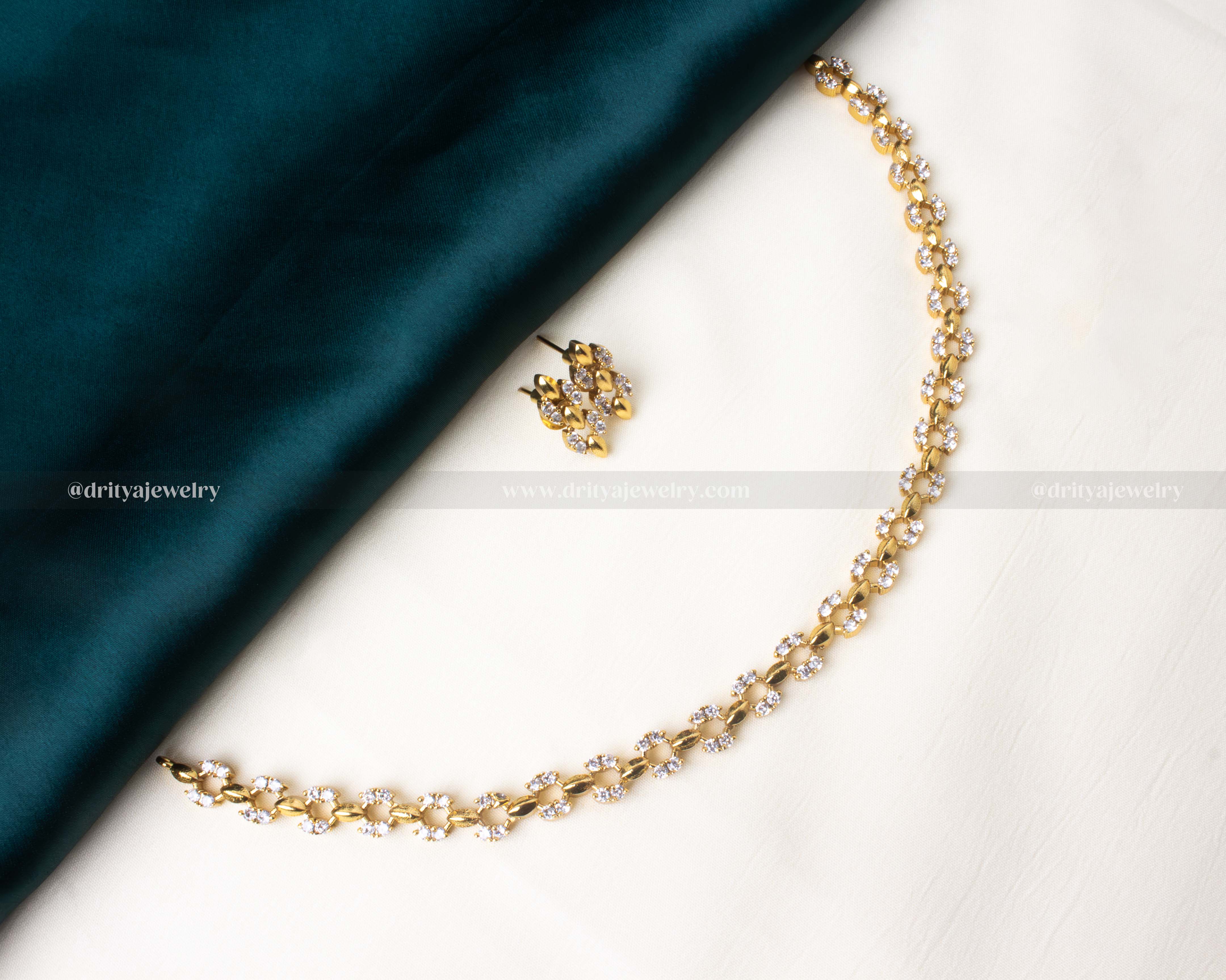 Elegant short necklace set adorned with white AD stones and matching earrings.