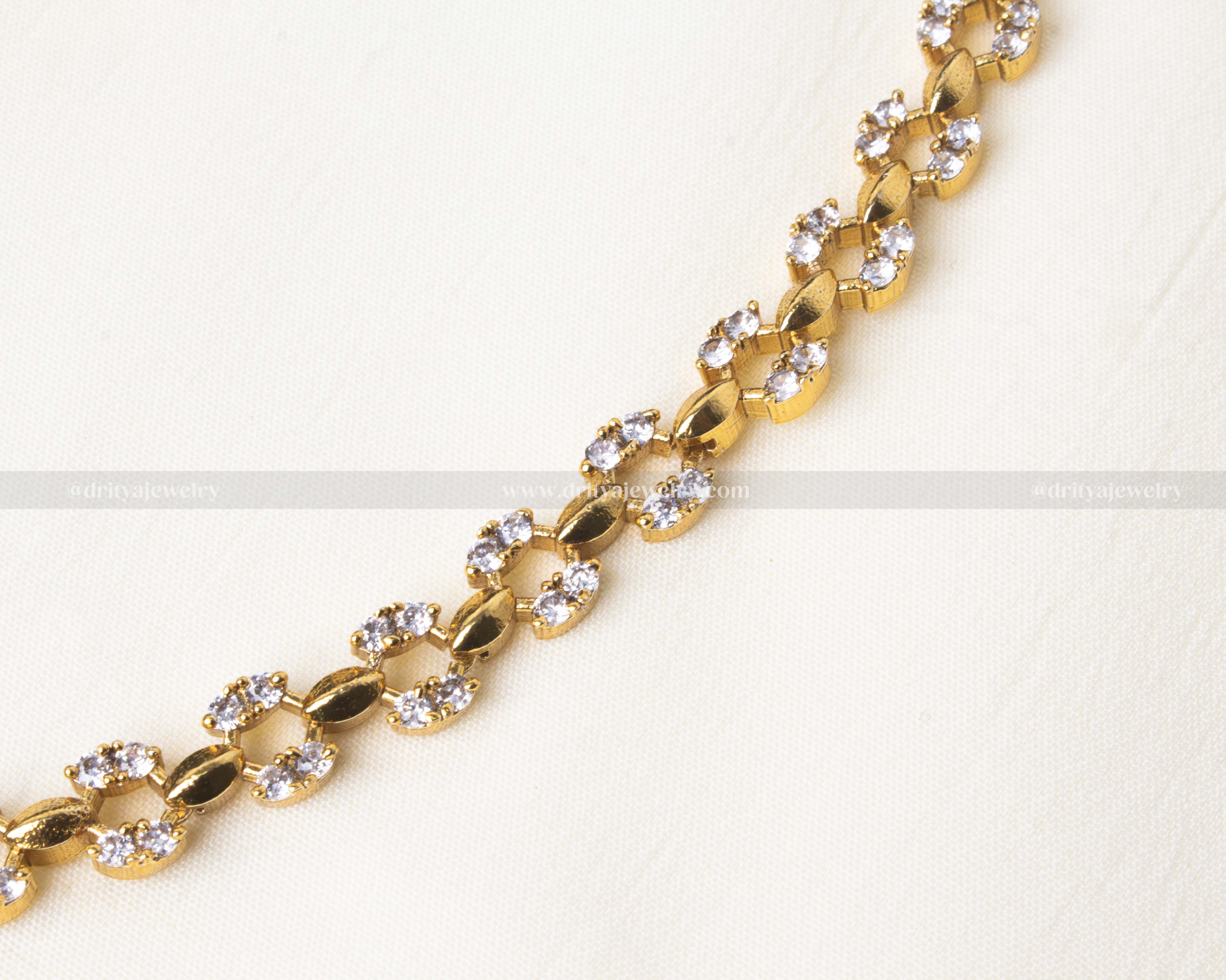 Elegant short necklace set adorned with white AD stones and matching earrings.