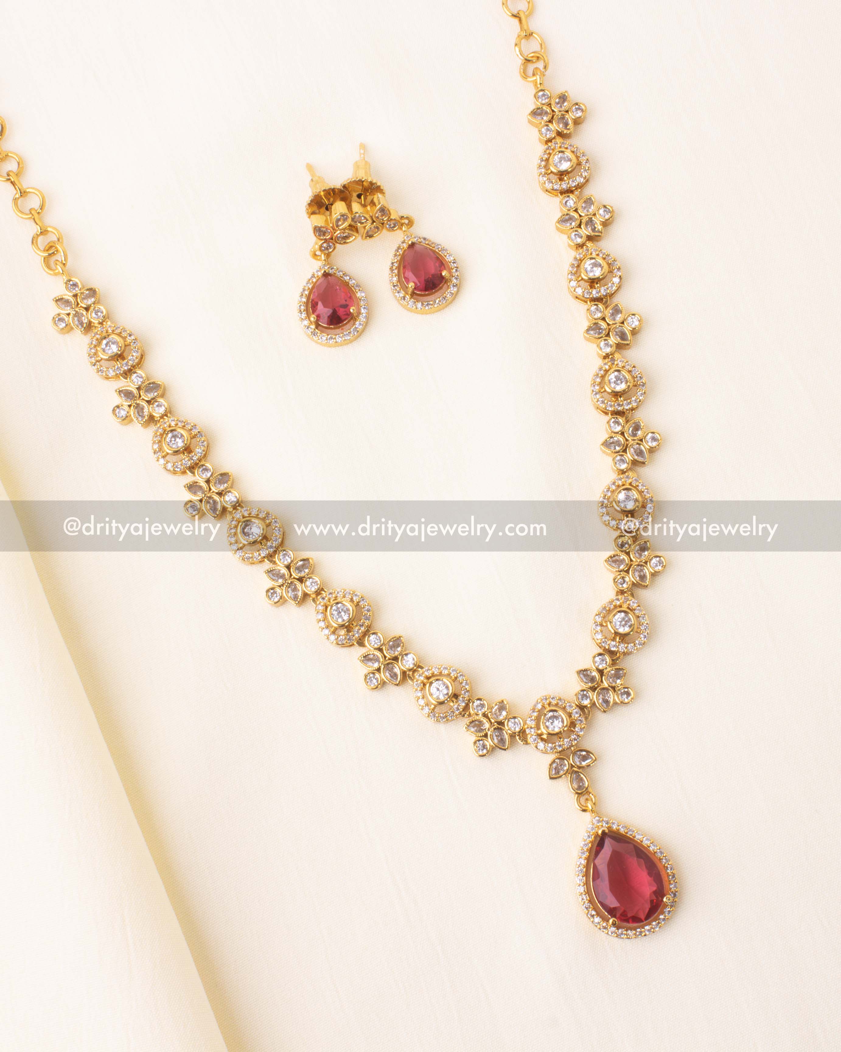 Red drop necklace set in gold-plated finish with floral CZ motifs.