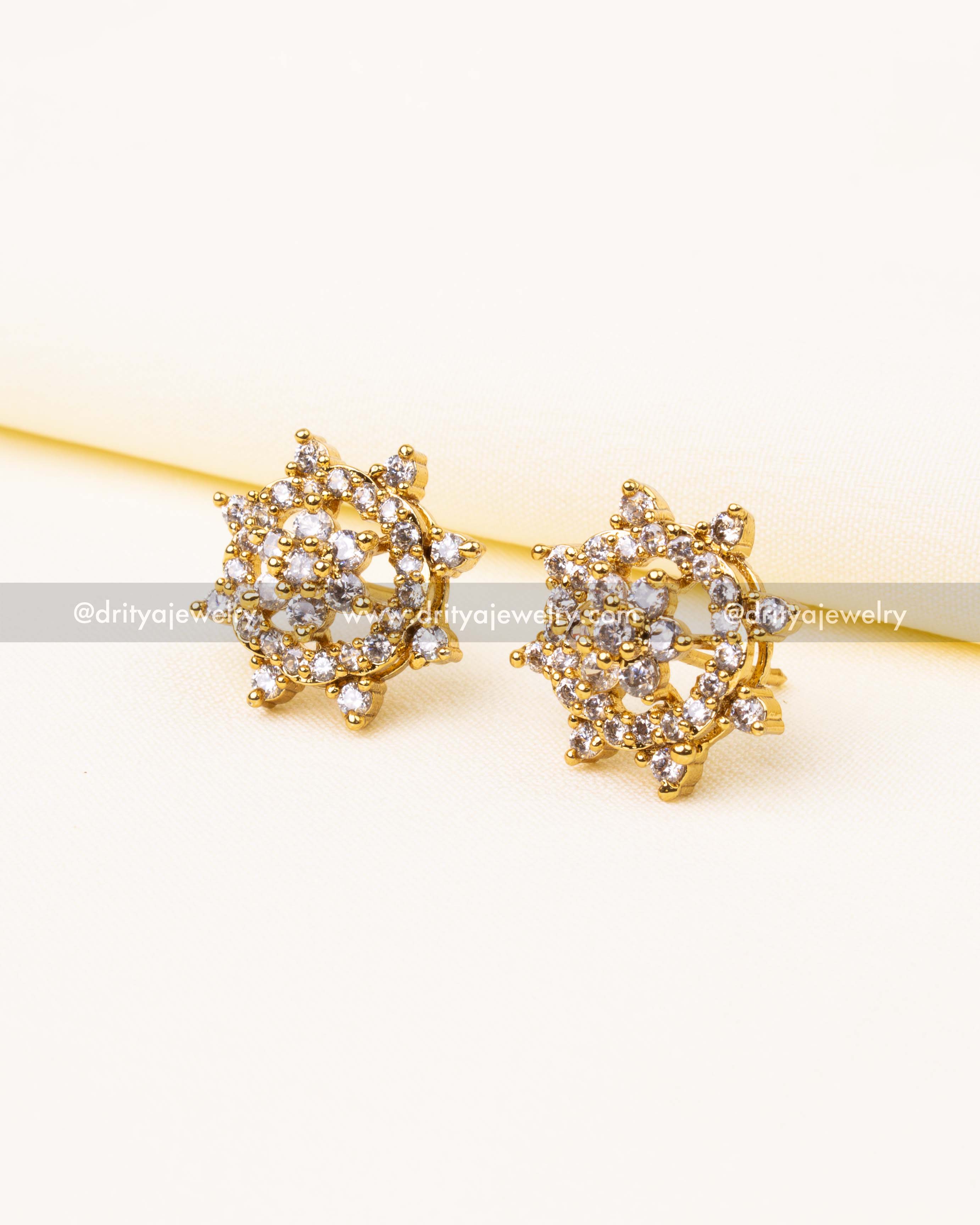 Side view of premium diamond-like CZ stud earrings with gold plating and cluster setting.