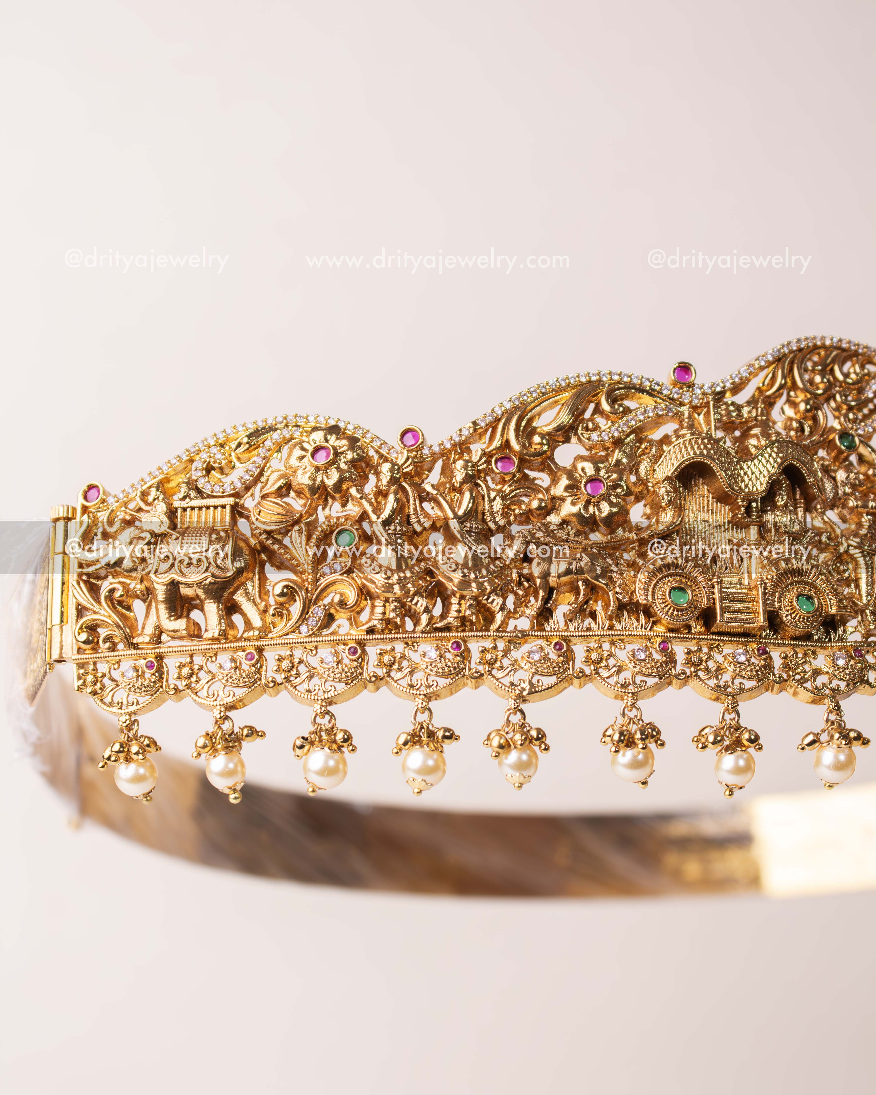 Detailed side view showing intricate carvings of elephants, temples, and floral patterns.