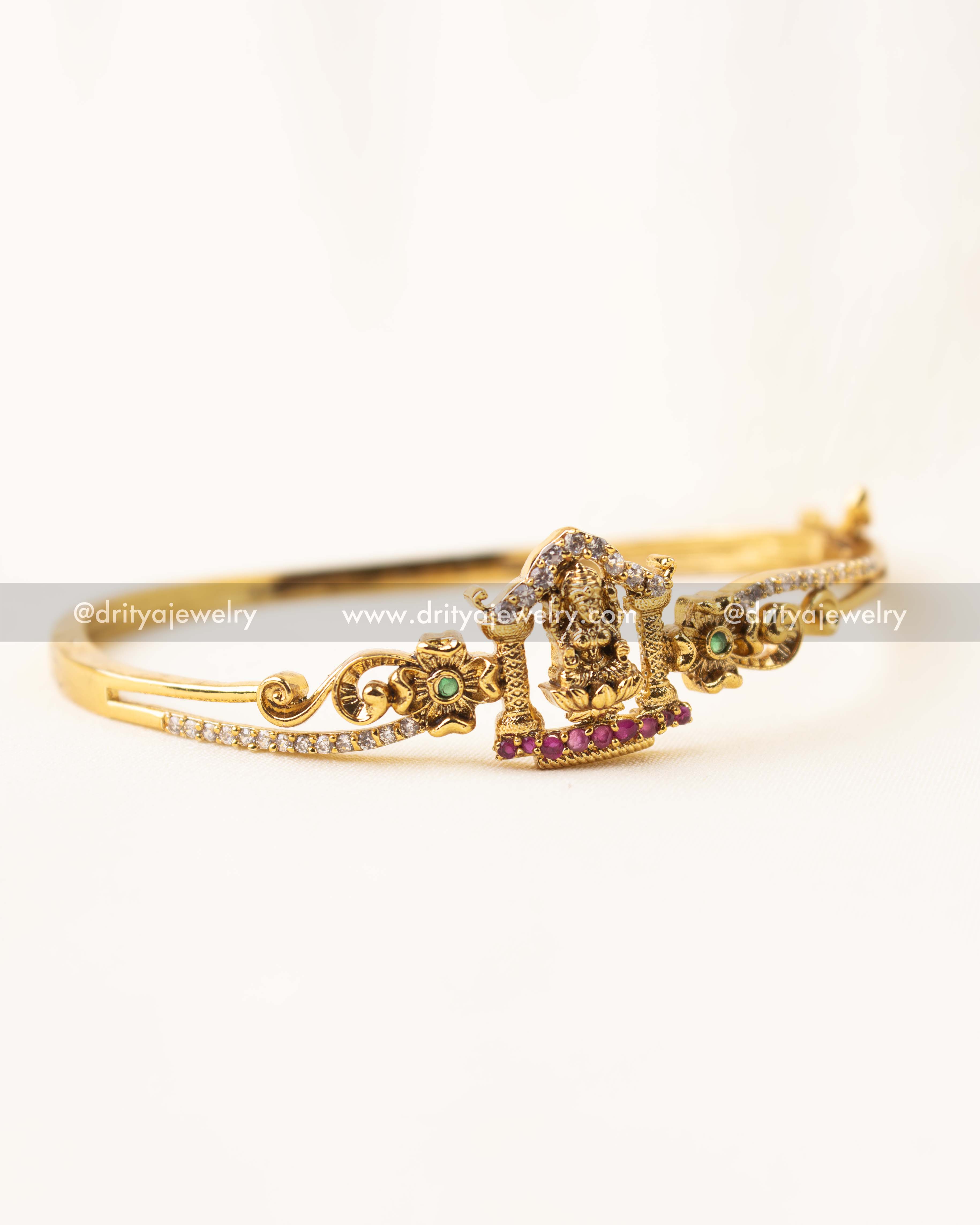 Gold-plated openable kada with Lakshmi Devi idol and CZ stones.