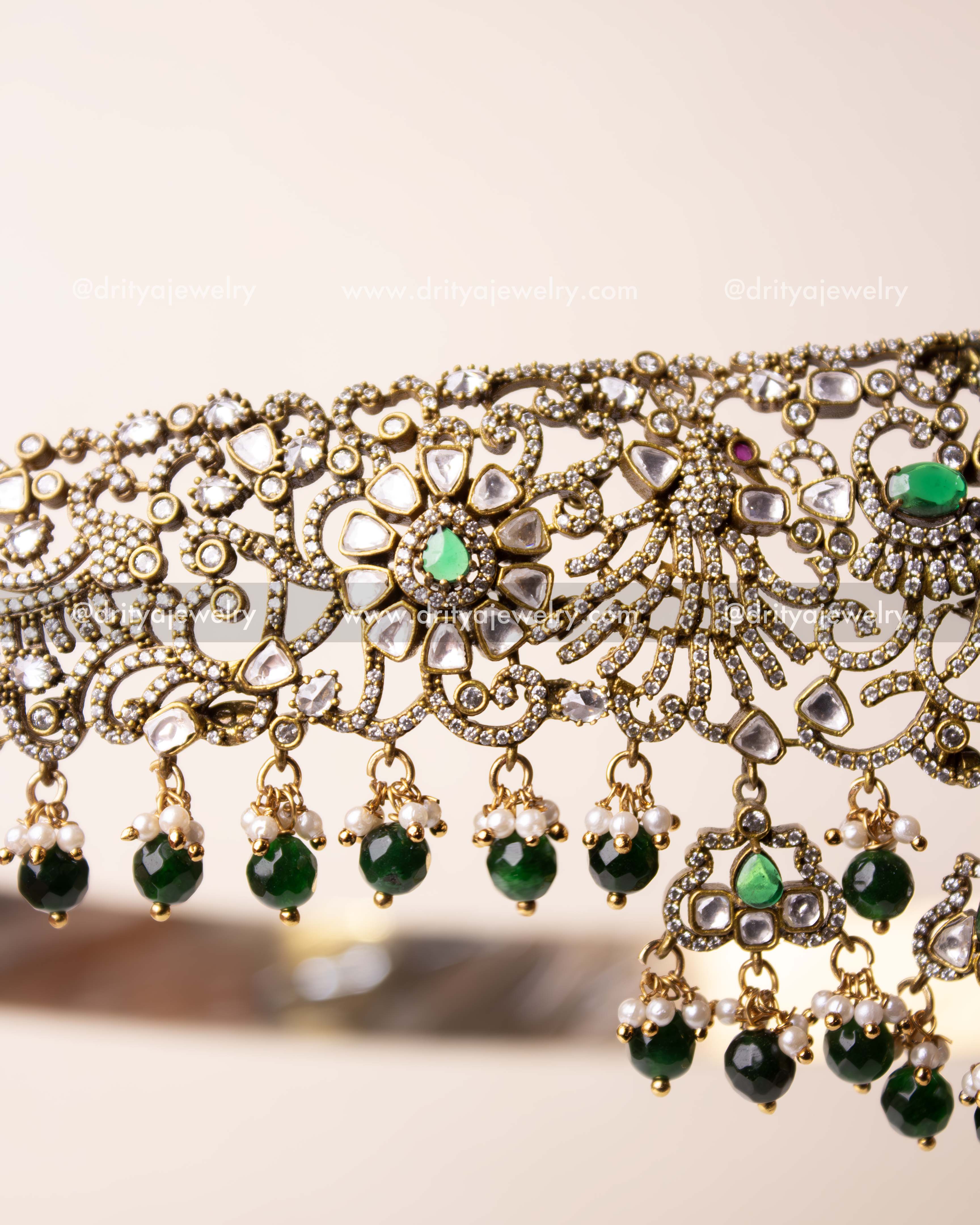 Close-up of floral motifs and antique polish with kundan stone accents.