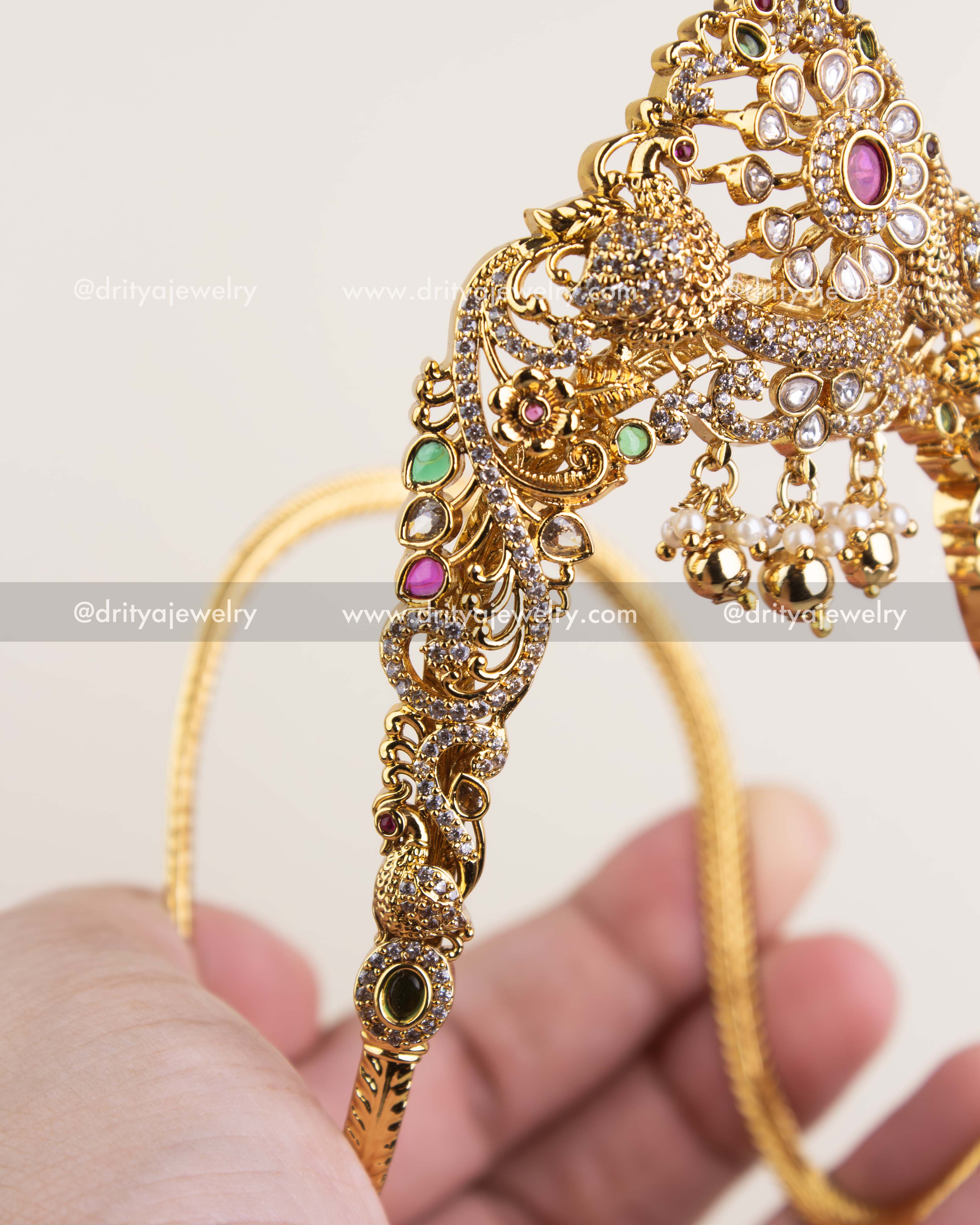 Intricate side design of Ara Vanki with peacock and floral patterns set with CZ stones.