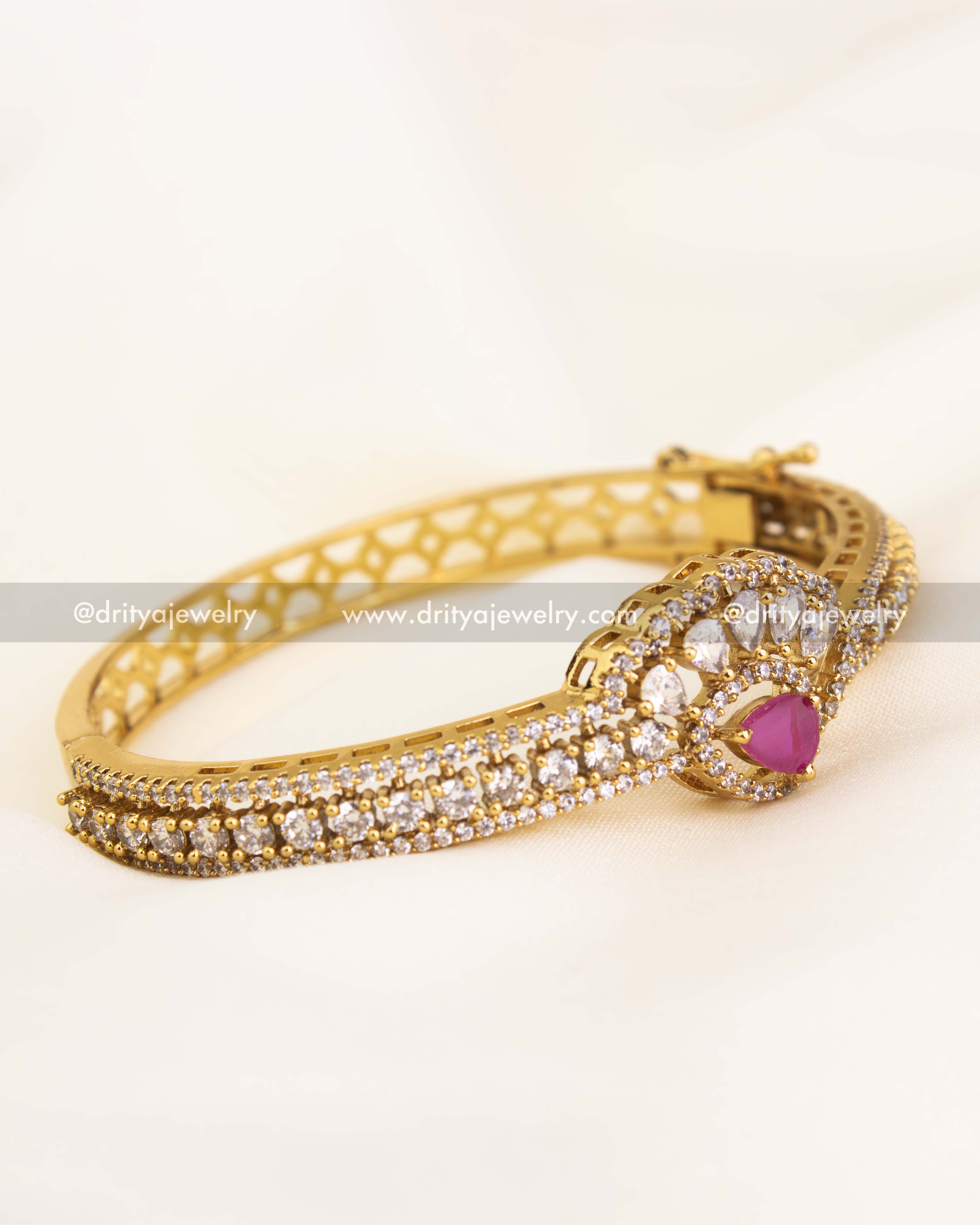 Premium free size kada featuring CZ stones and a central ruby accent, gold plated for elegance.