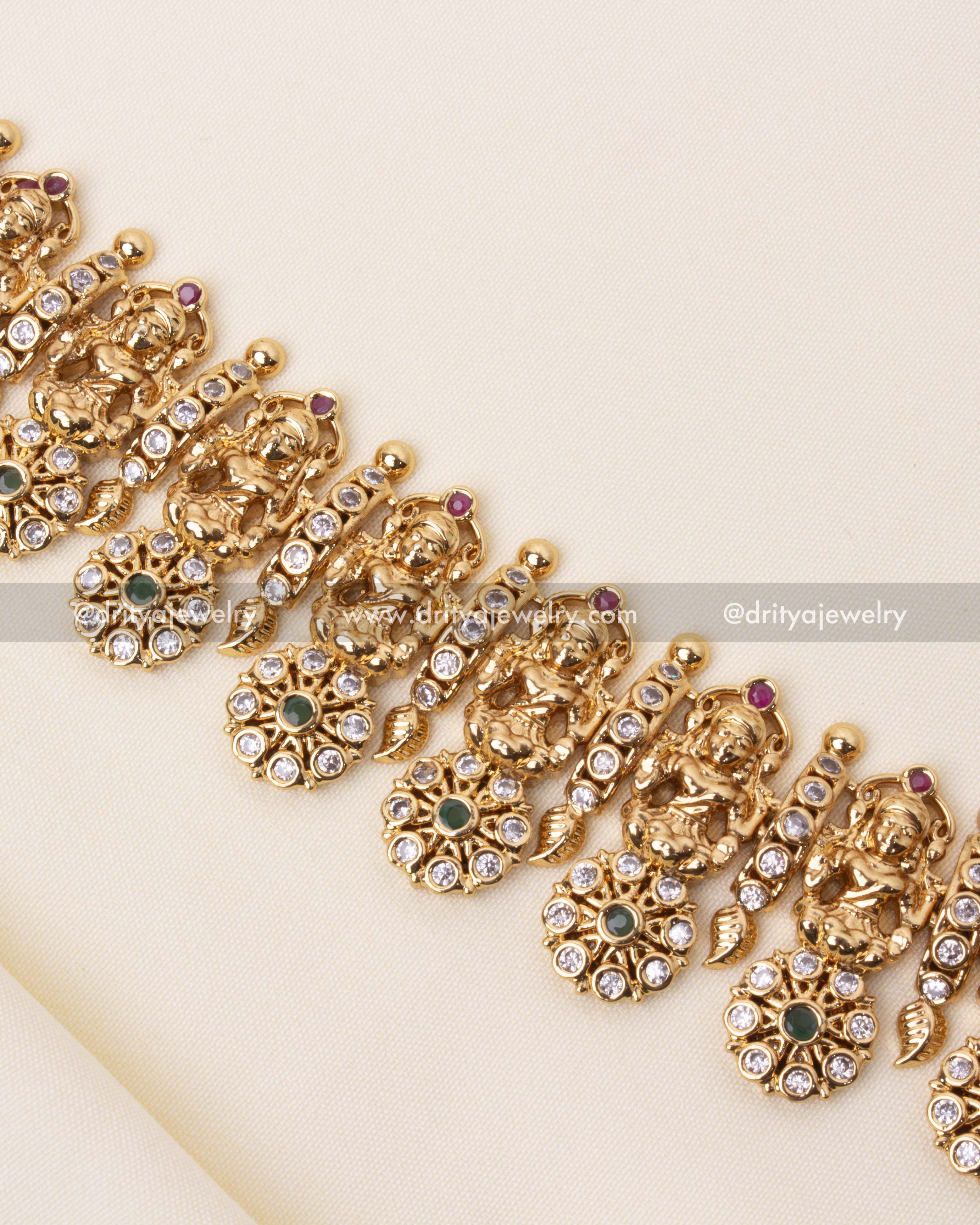 Temple jewelry necklace with detailed carvings of goddess figures and floral patterns.