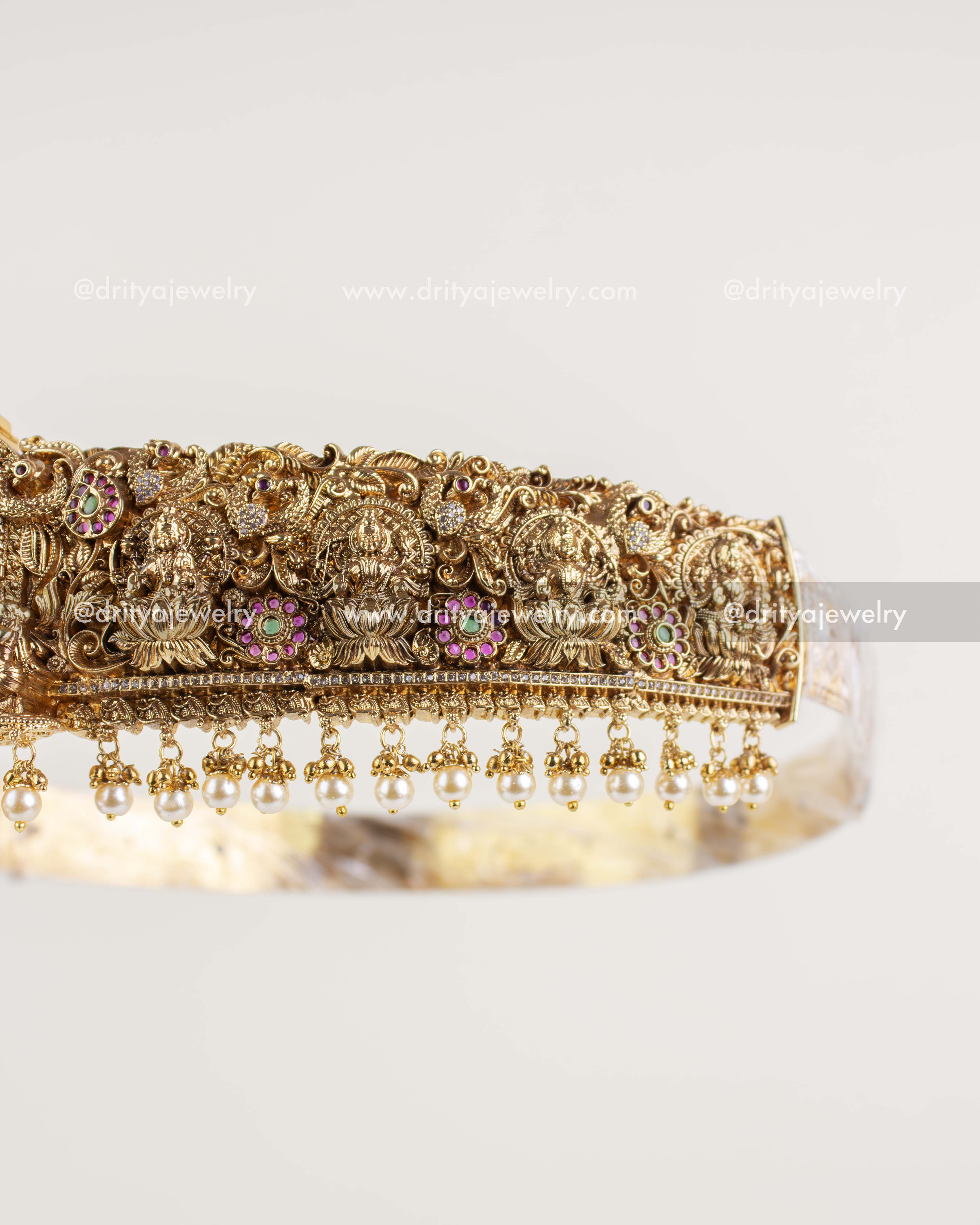 Side detailing of Nakshi vadanam with goddess motifs, floral vines, and peacocks.