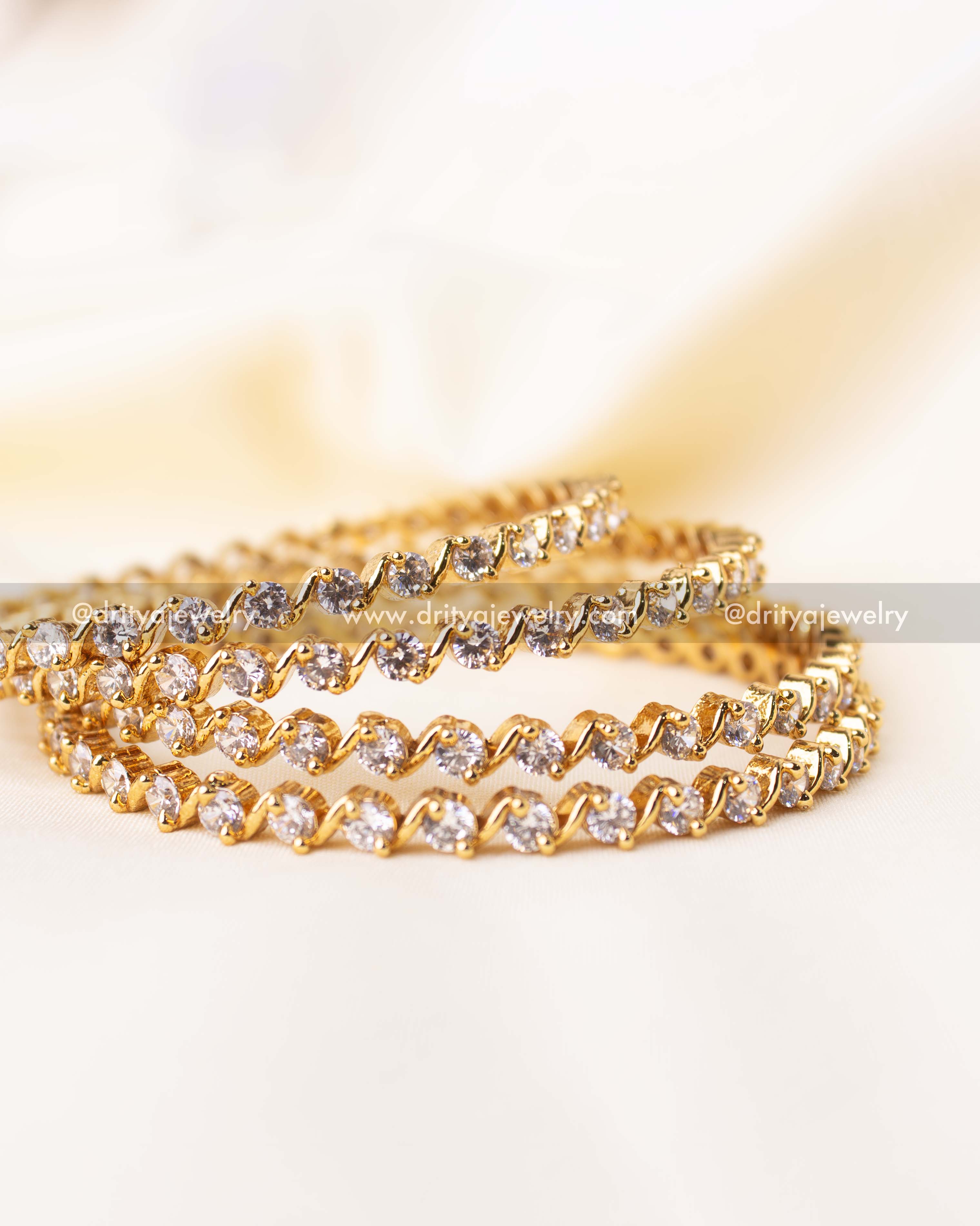Detailed close-up of solitaire look-alike bangles with prong-set sparkling white stones