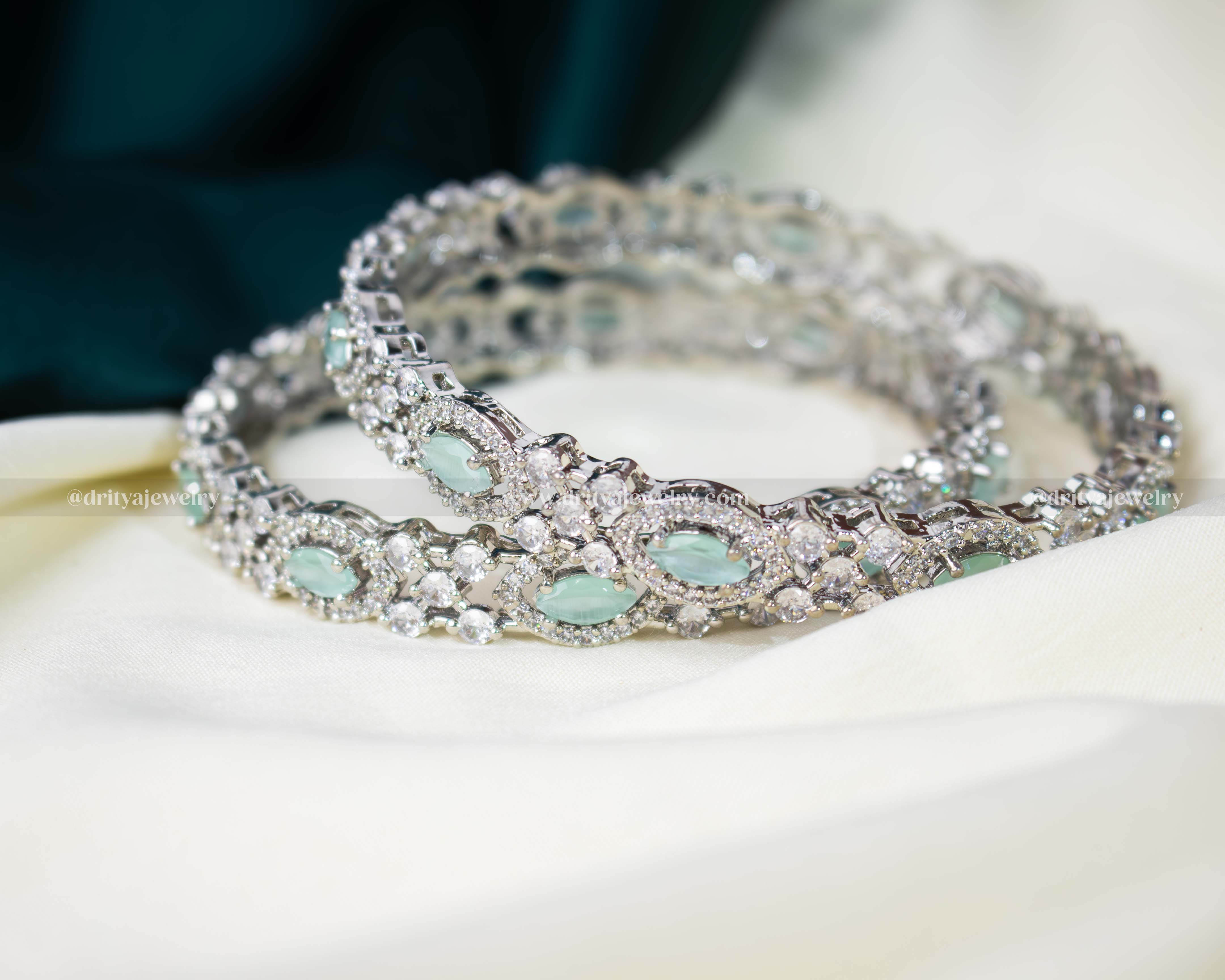 A stack of Mint Green CZ Bangles by Dritya Jewelry, perfect for versatile styling options.
