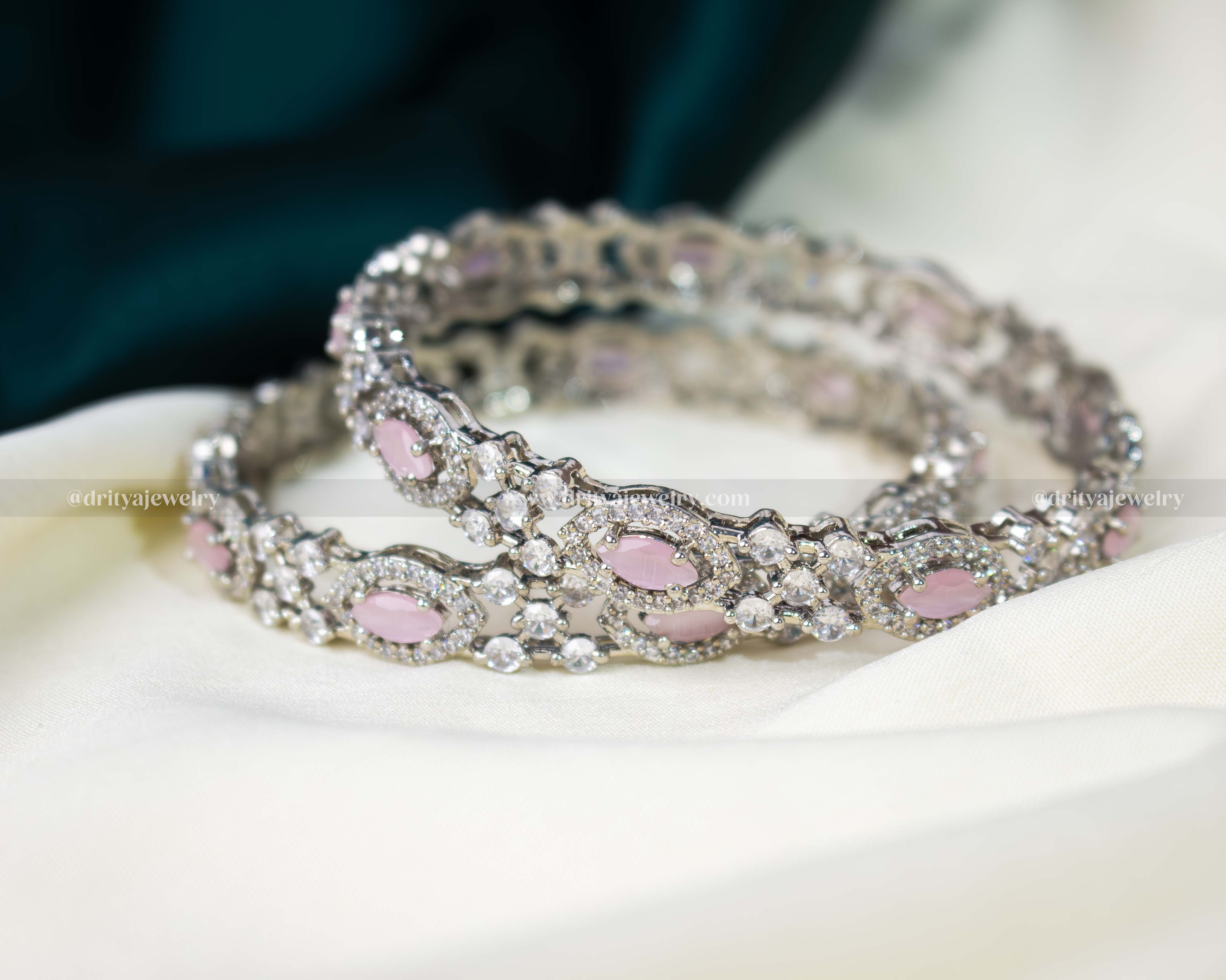A stack of Pink CZ Bangles by Dritya Jewelry, perfect for versatile styling options.