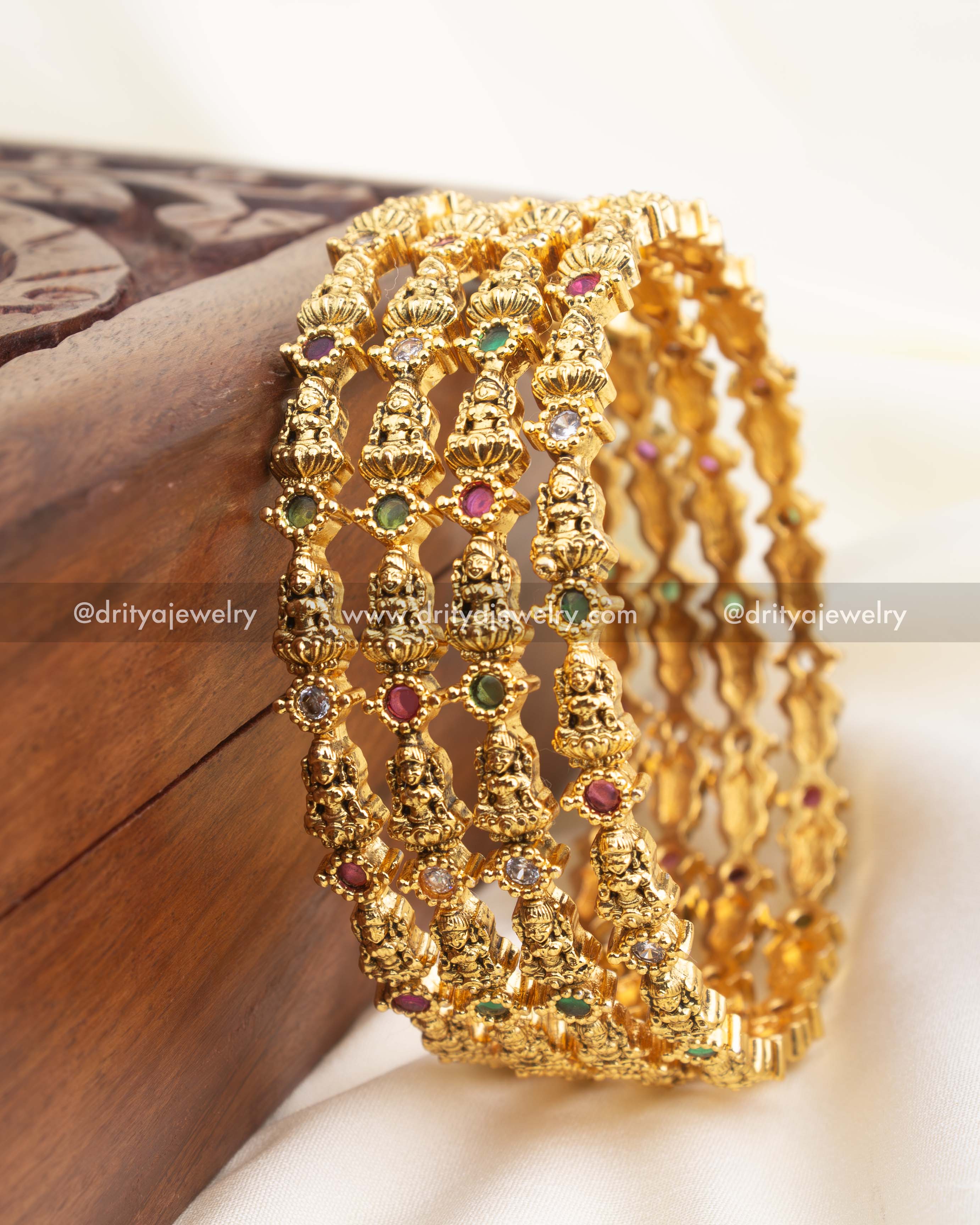 Premium gold-plated temple bangles with detailed Nakshi work and multicolour CZ accents.