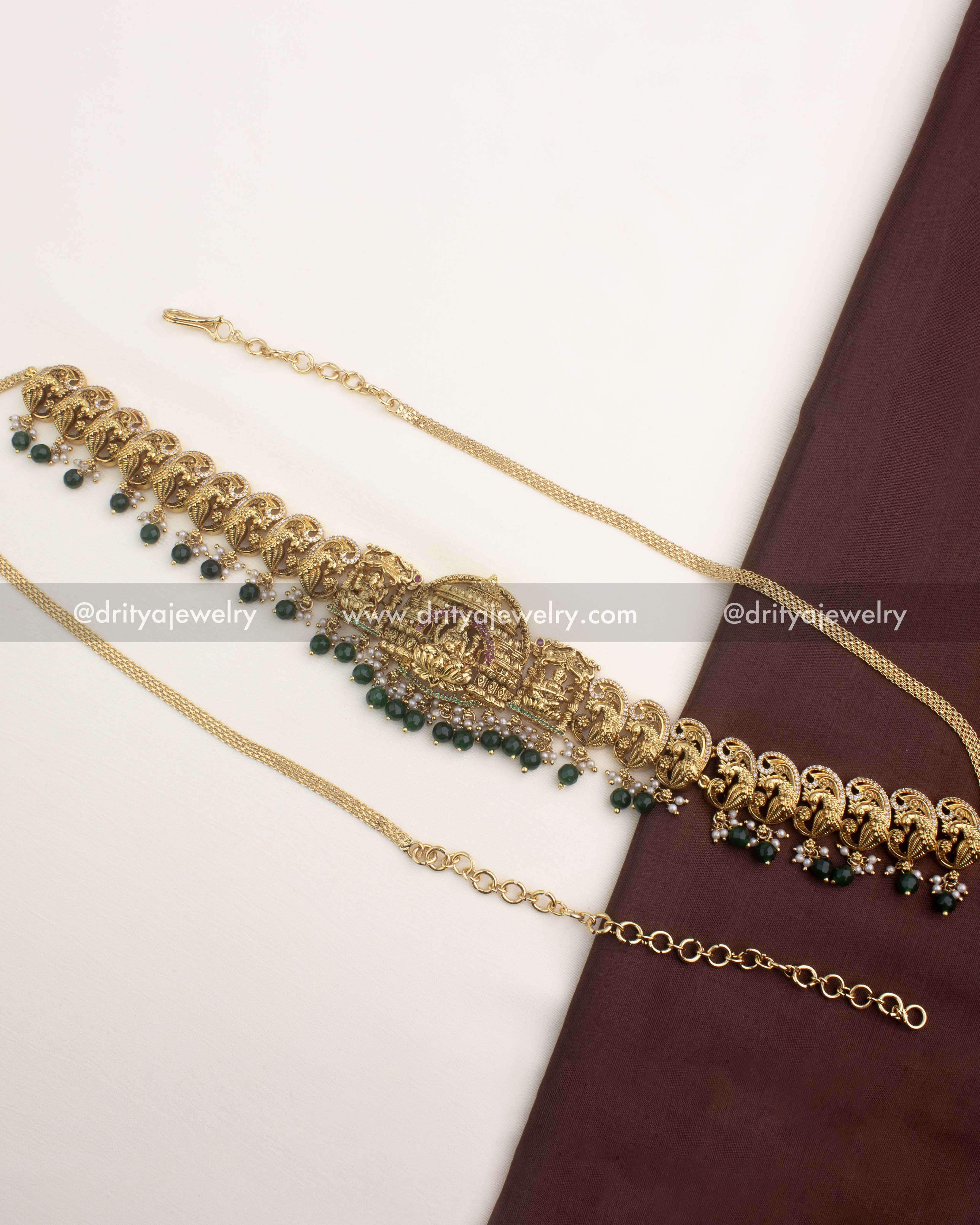 Premium temple-style hip chain with nakshi peacock motifs and emerald green bead hangings.