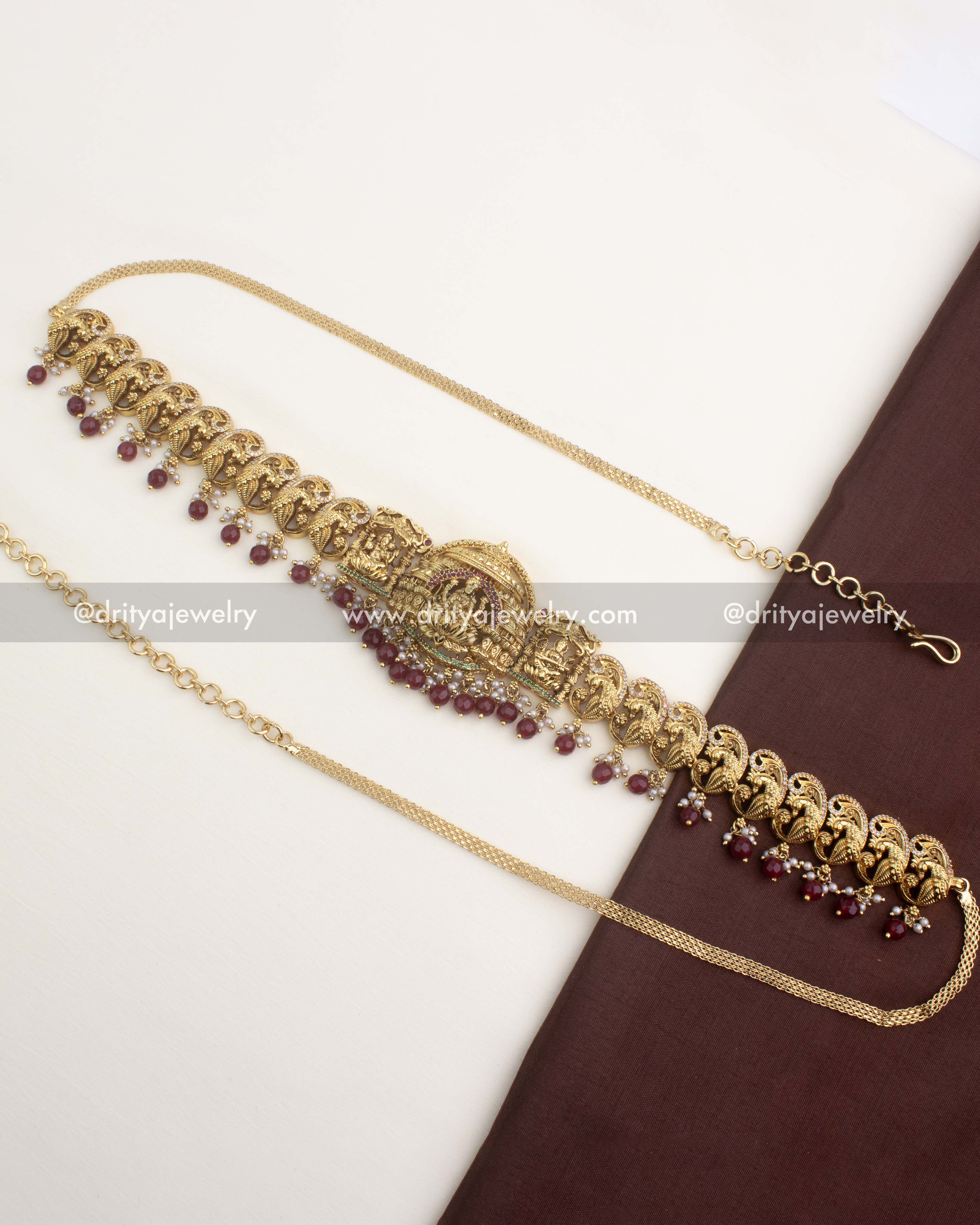 Premium nakshi temple hip belt with ruby red bead hangings and peacock motifs.