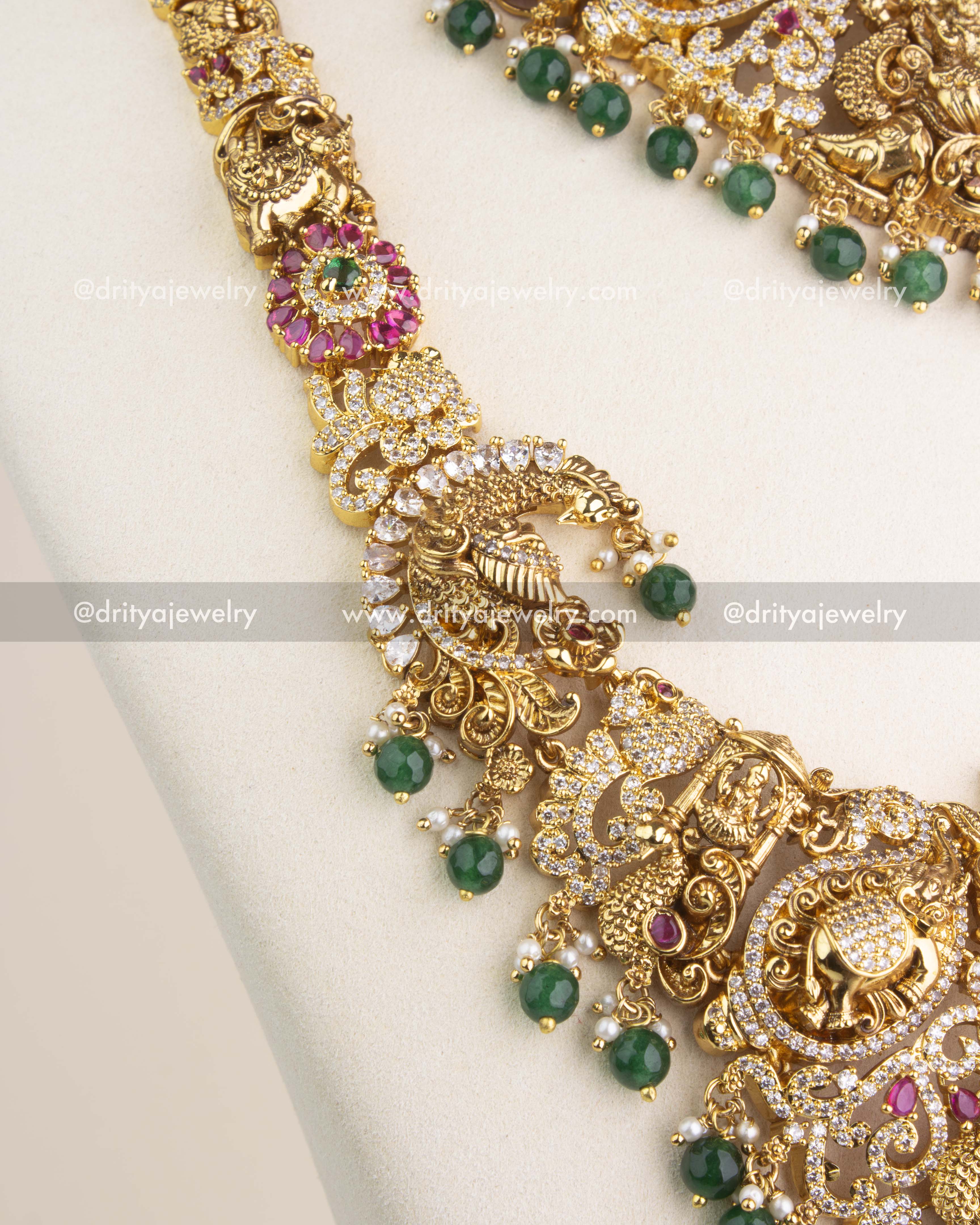Temple-style Nakshi chain with ruby kemp accents and shimmering CZ stone embellishments.
