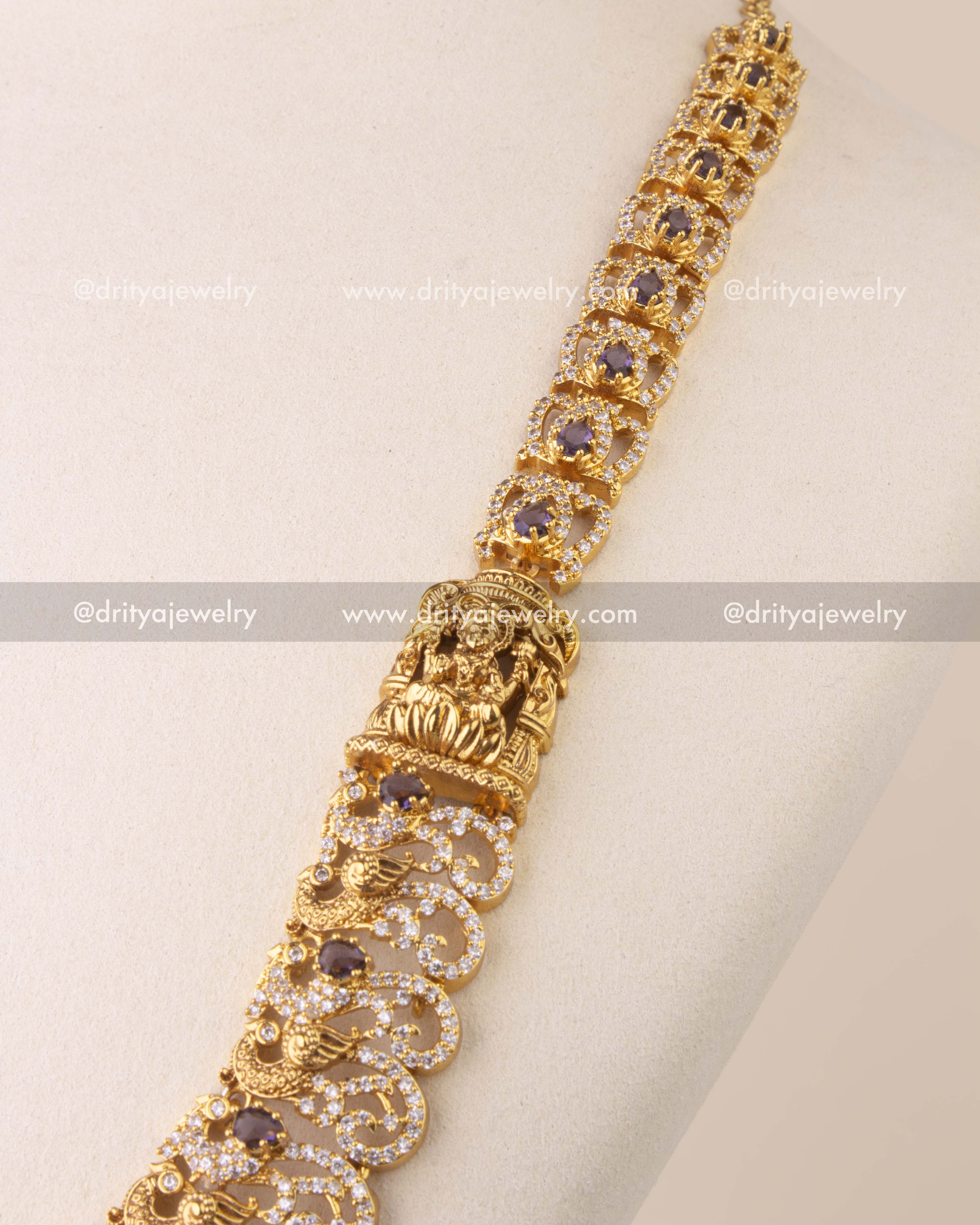 Close-up of temple-style Nakshi necklace with intricate peacock motifs and gold bead accents.