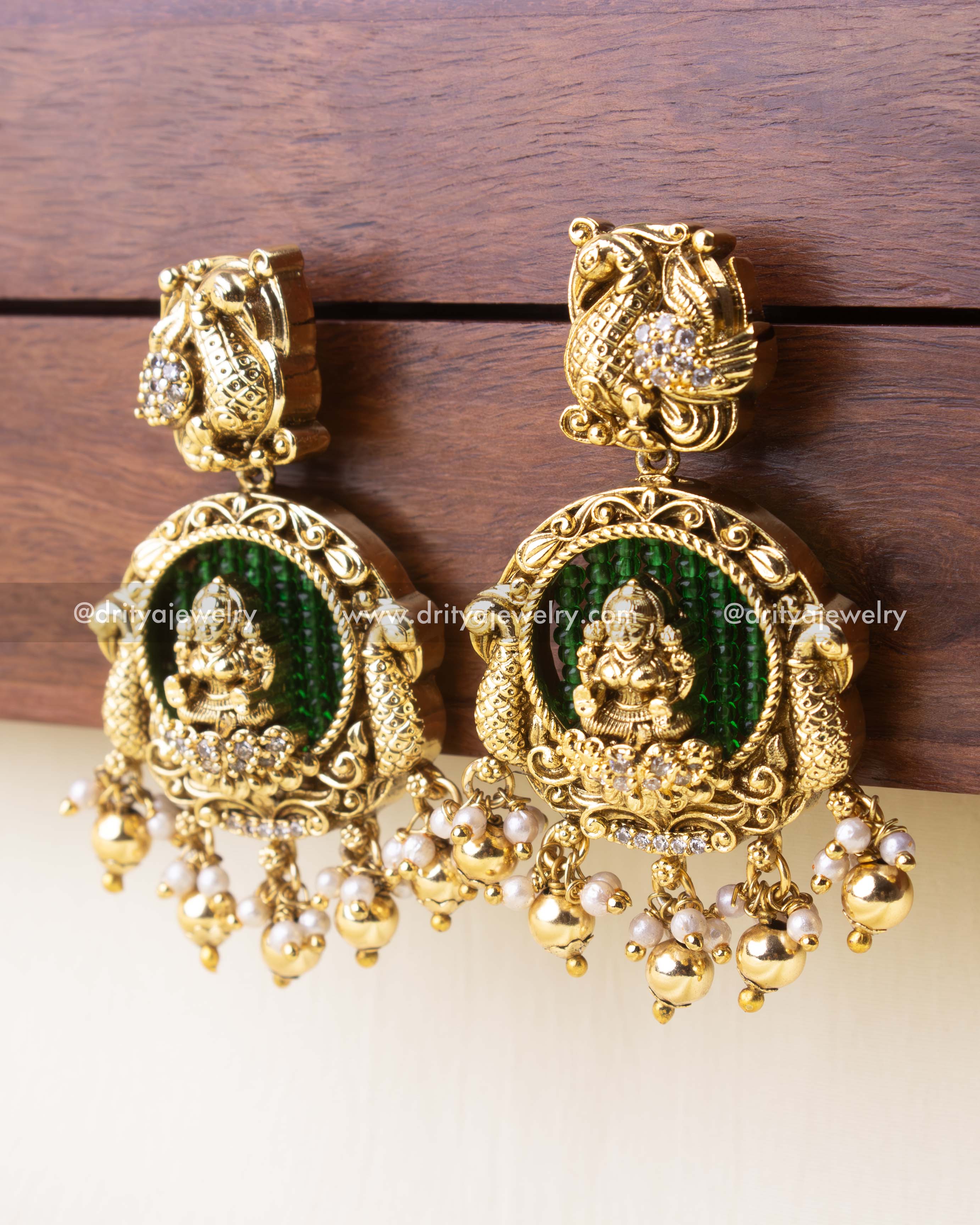 Antique earrings with green background beads and classic golden bead danglers.