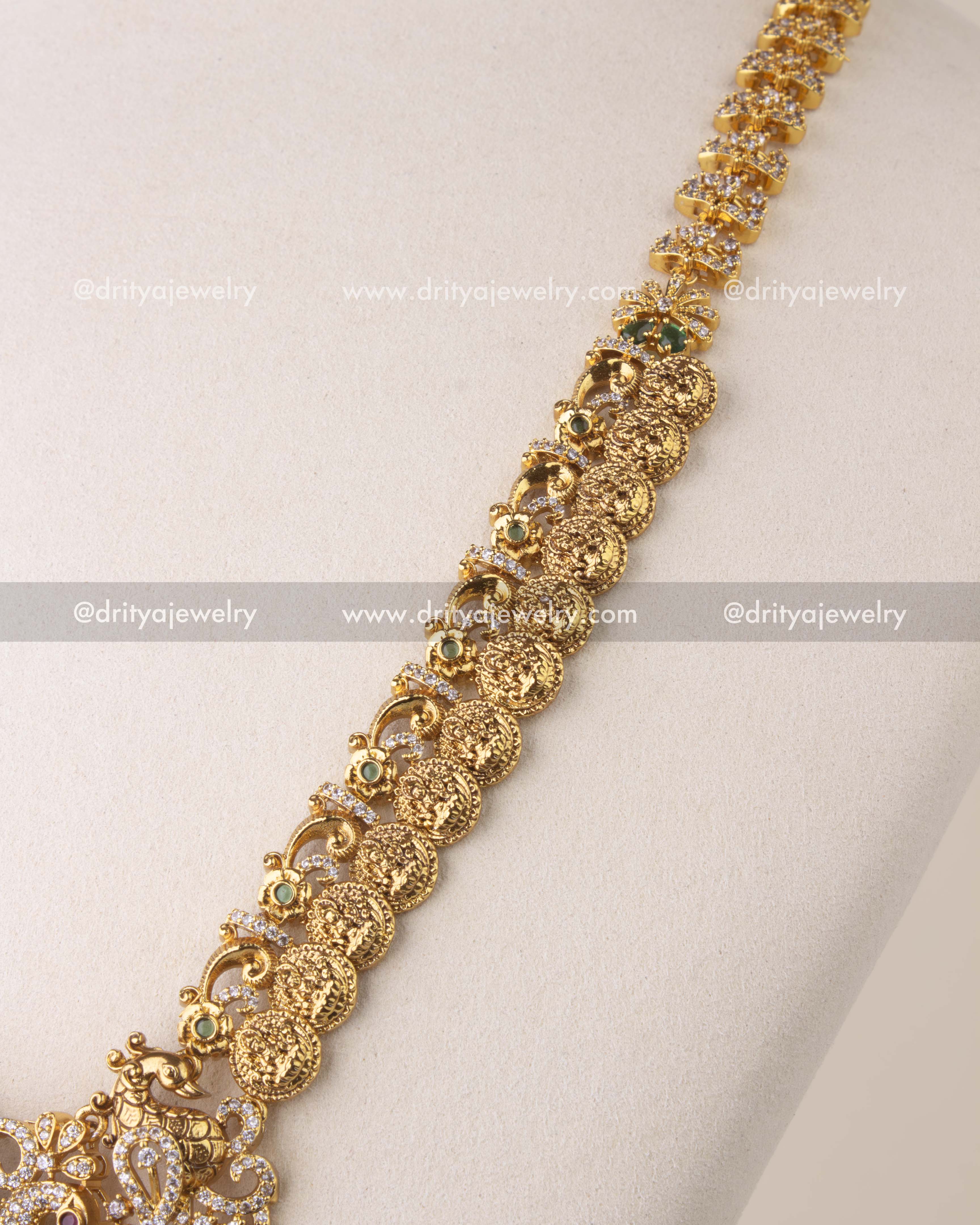 Close-up of Kasulu chain long necklace with Nakshi coin details, green accents, and CZ stone embellishments