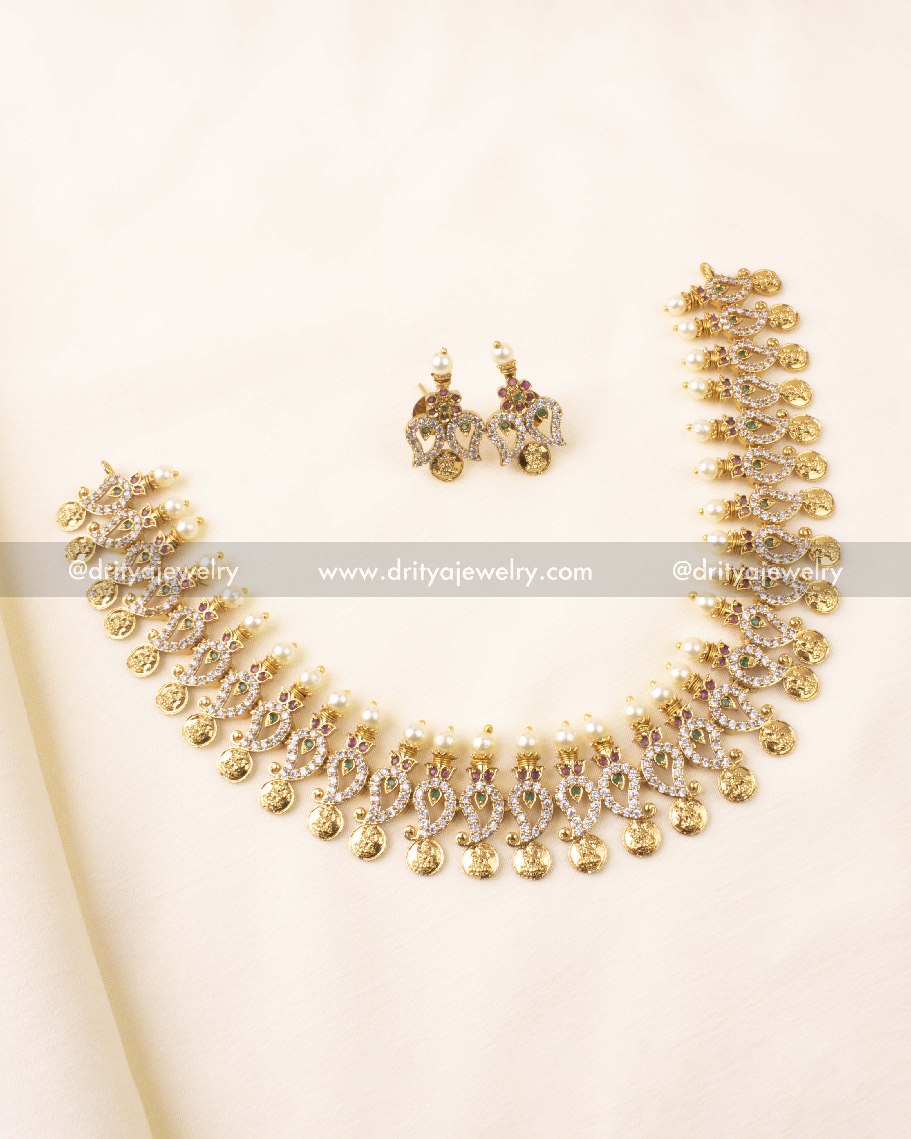 Temple-style short necklace set with coin motifs, peacock detailing, and matching earrings.