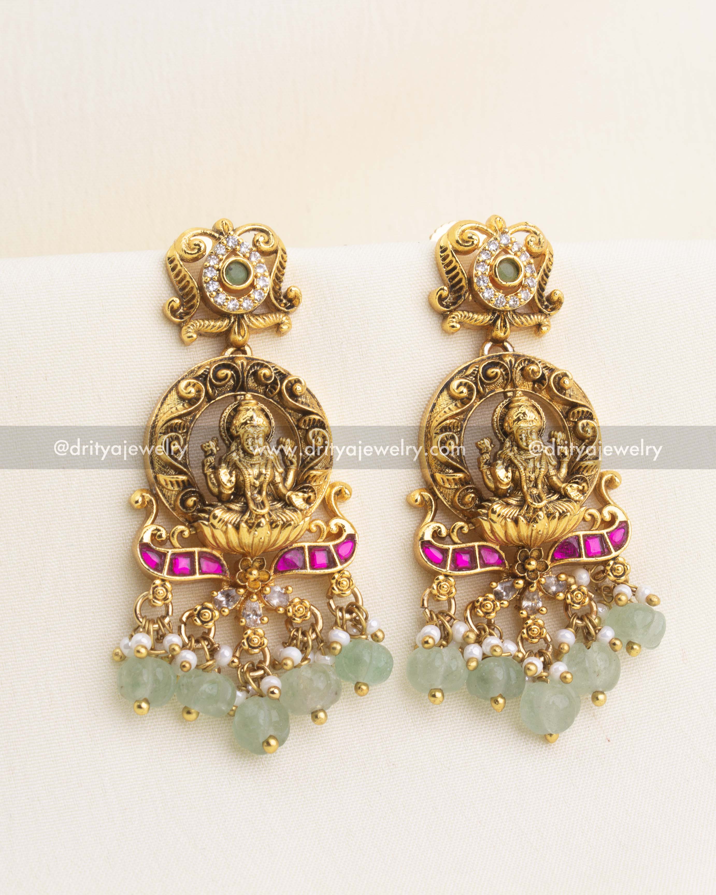 Pair of antique gold Lakshmi earrings with kemp stones, pearl clusters, and pastel green bead drops