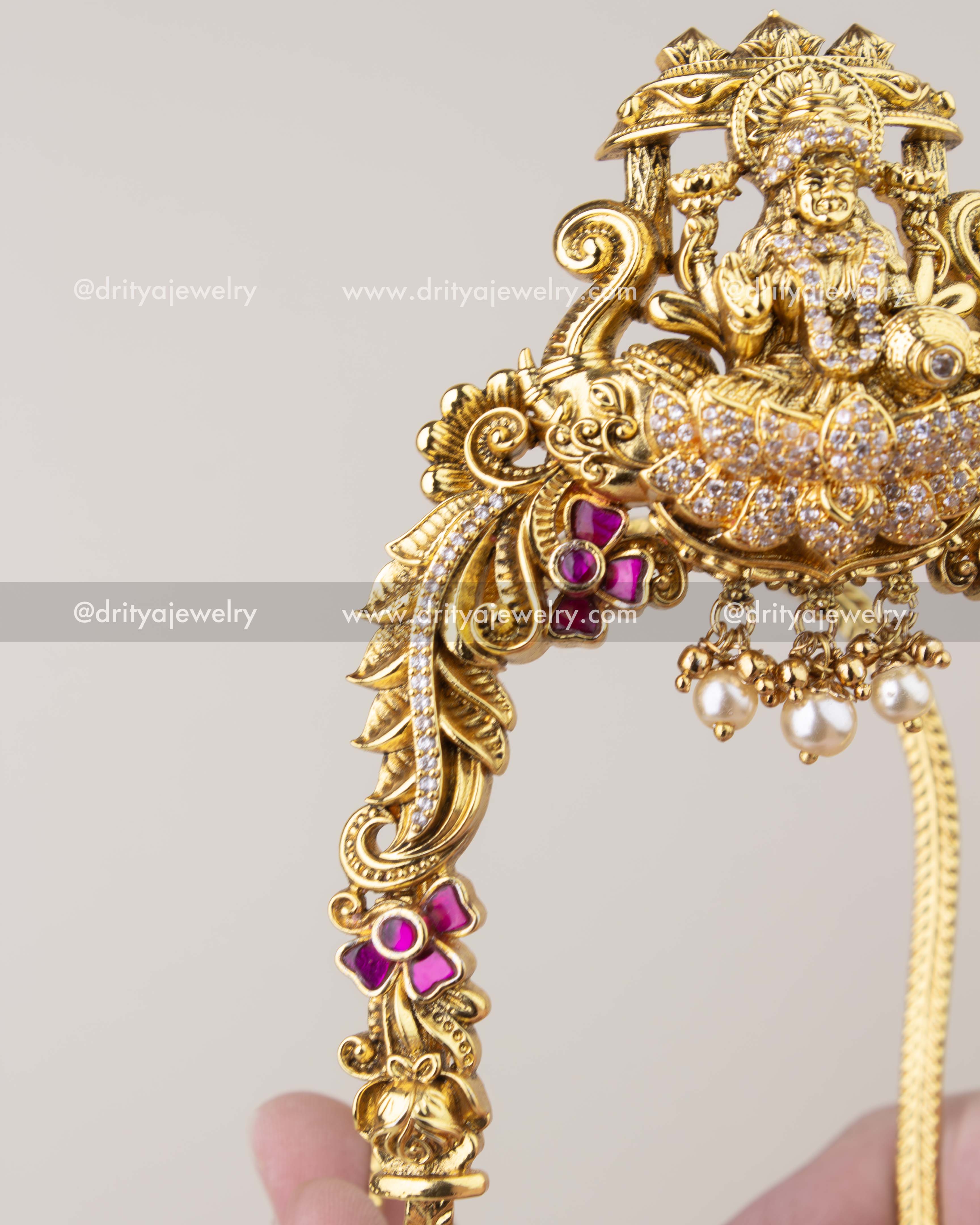 Side view of antique gold Kemp vanki with floral motifs and curved armlet design