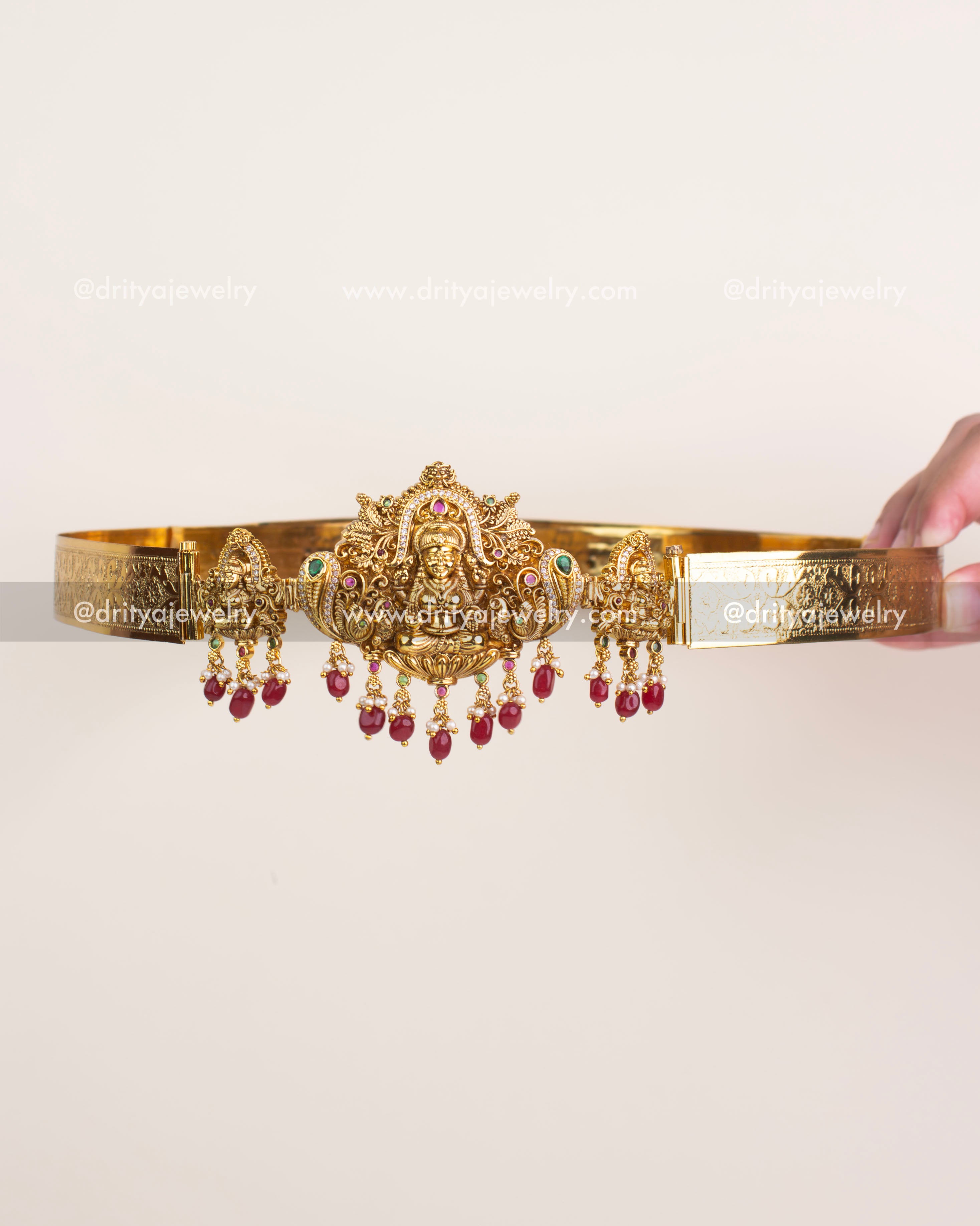 Antique gold temple waist belt with Goddess Lakshmi motif and ruby bead hangings.