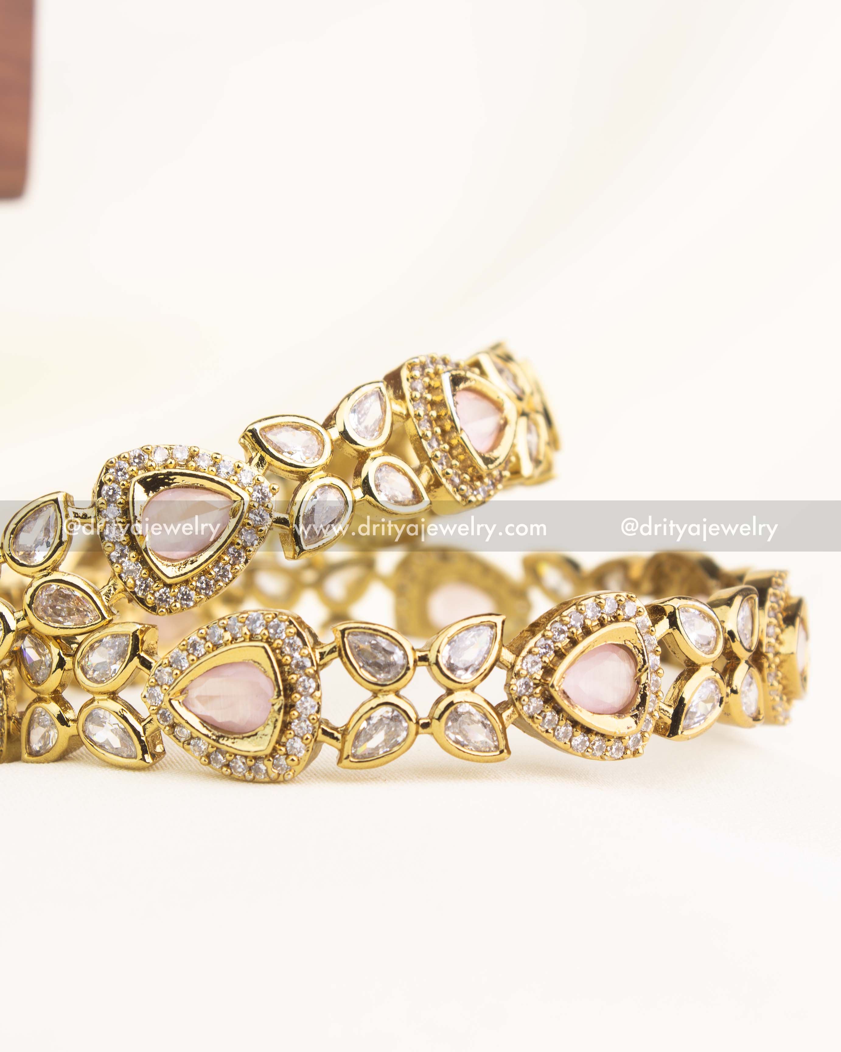 Victorian gold-plated bangles with blush pink AD stones and teardrop detailing by Dritya Jewelry.