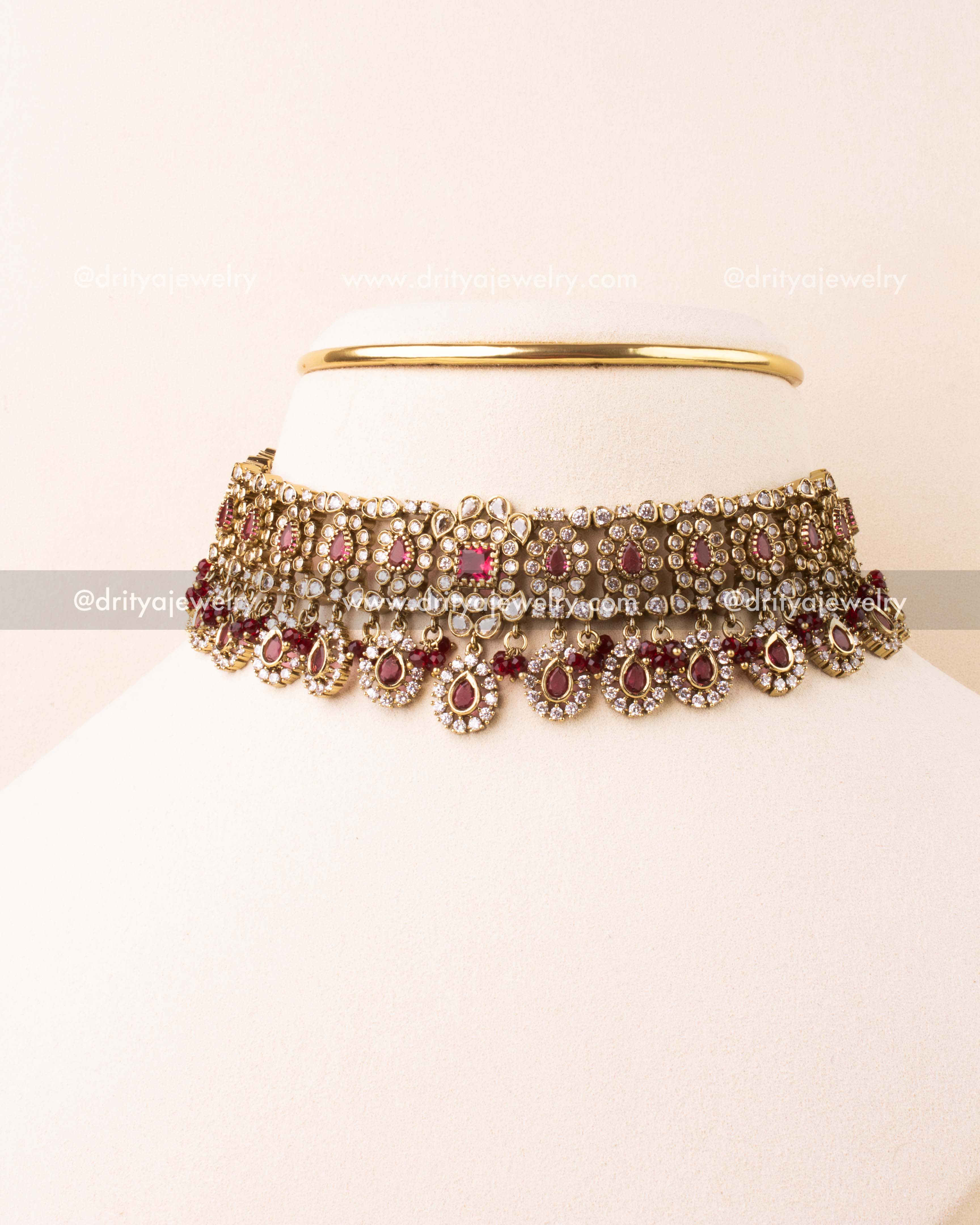 Ruby red Victorian choker necklace set with antique polish and matching earrings.