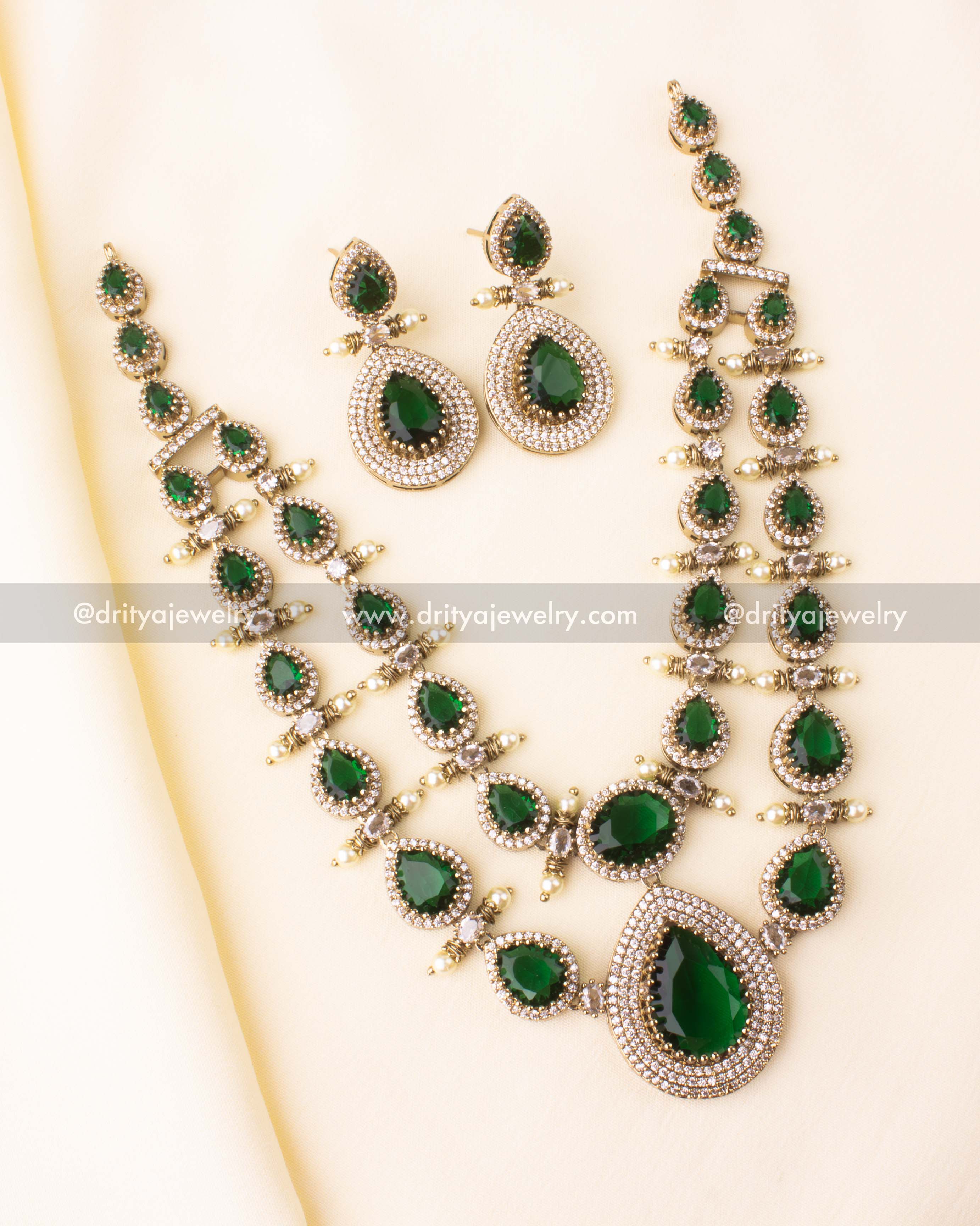 Premium Victorian layered short necklace with emerald-colored stones, zircon detailing, and pearl embellishments, paired with statement earrings.