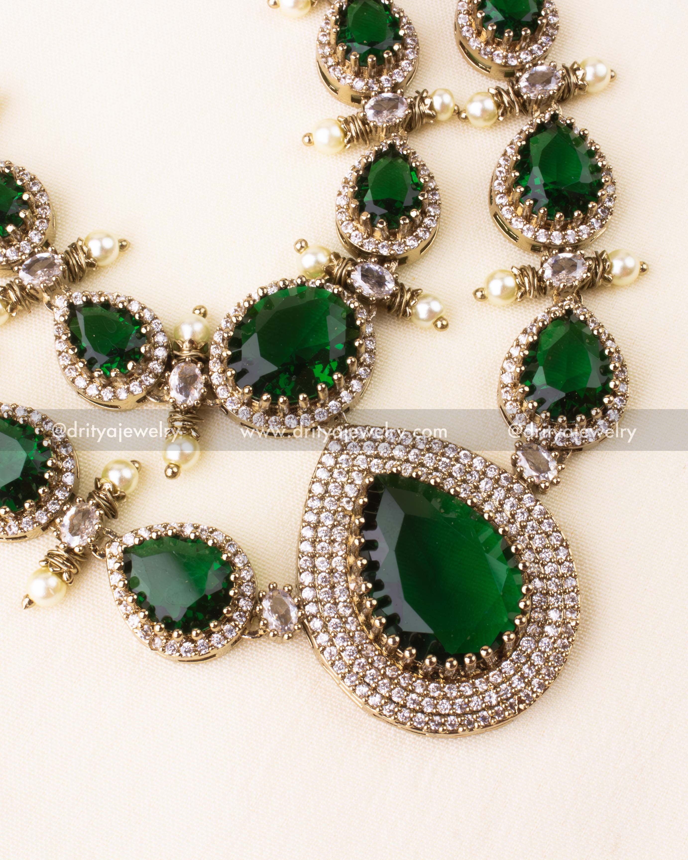 Premium Victorian layered short necklace with emerald-colored stones, zircon detailing, and pearl embellishments, paired with statement earrings.
