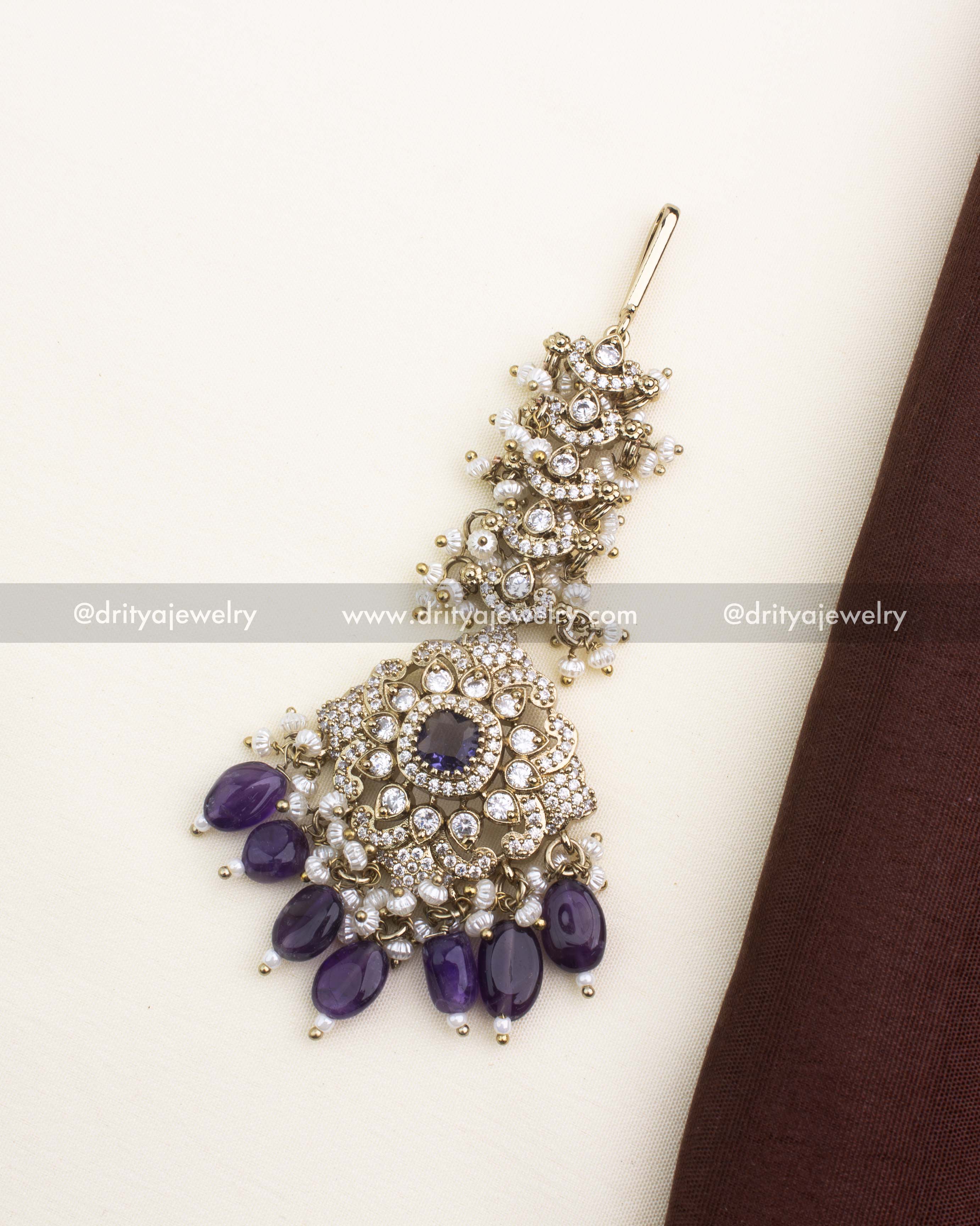 Victorian-style maang tikka with deep purple stones, CZ sparkle, and pearl accents.