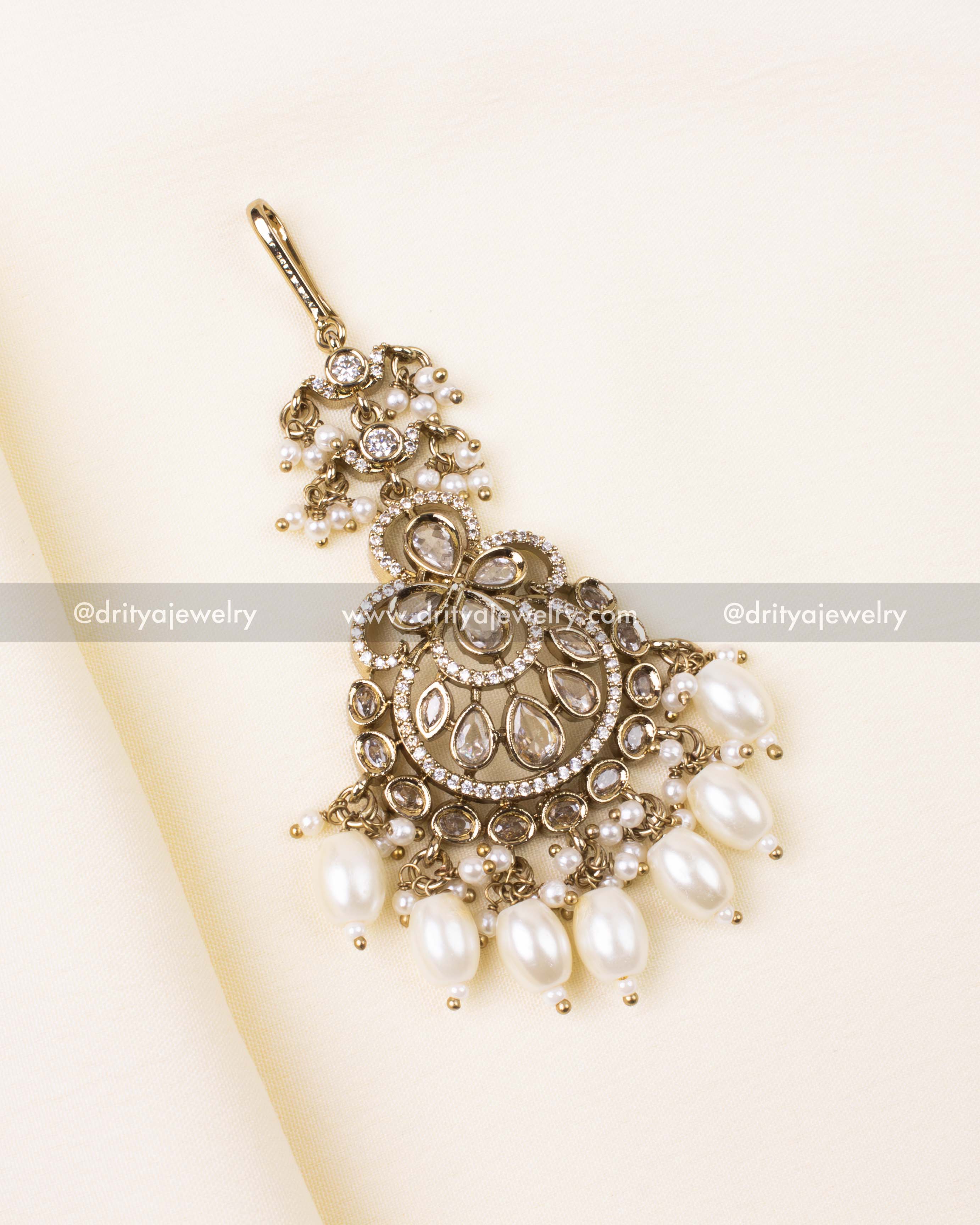 Elegant diamond-white Victorian maang tikka with pearl drops and antique gold detailing.