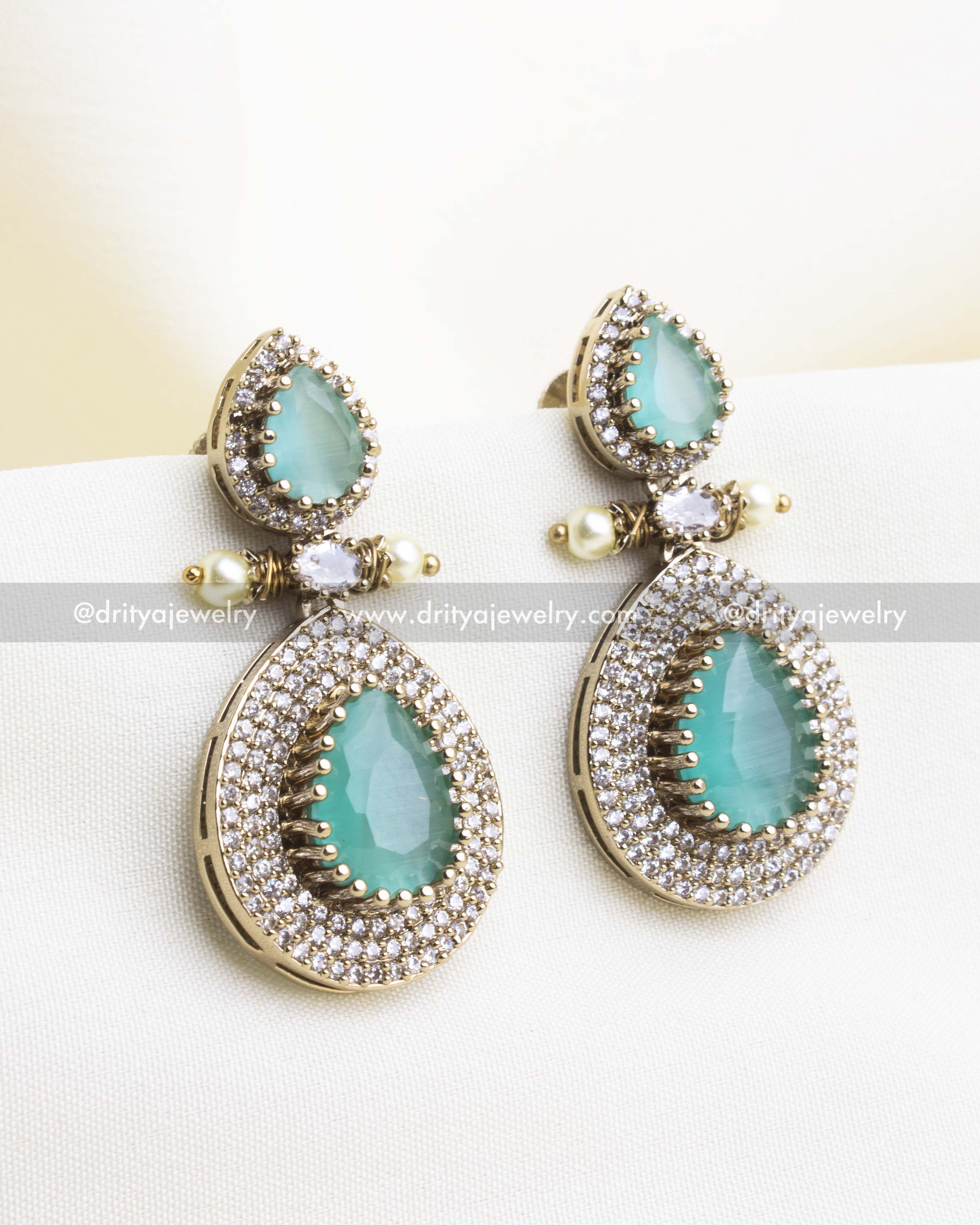 Pair of Victorian-style earrings with mint green stones and CZ diamond borders.