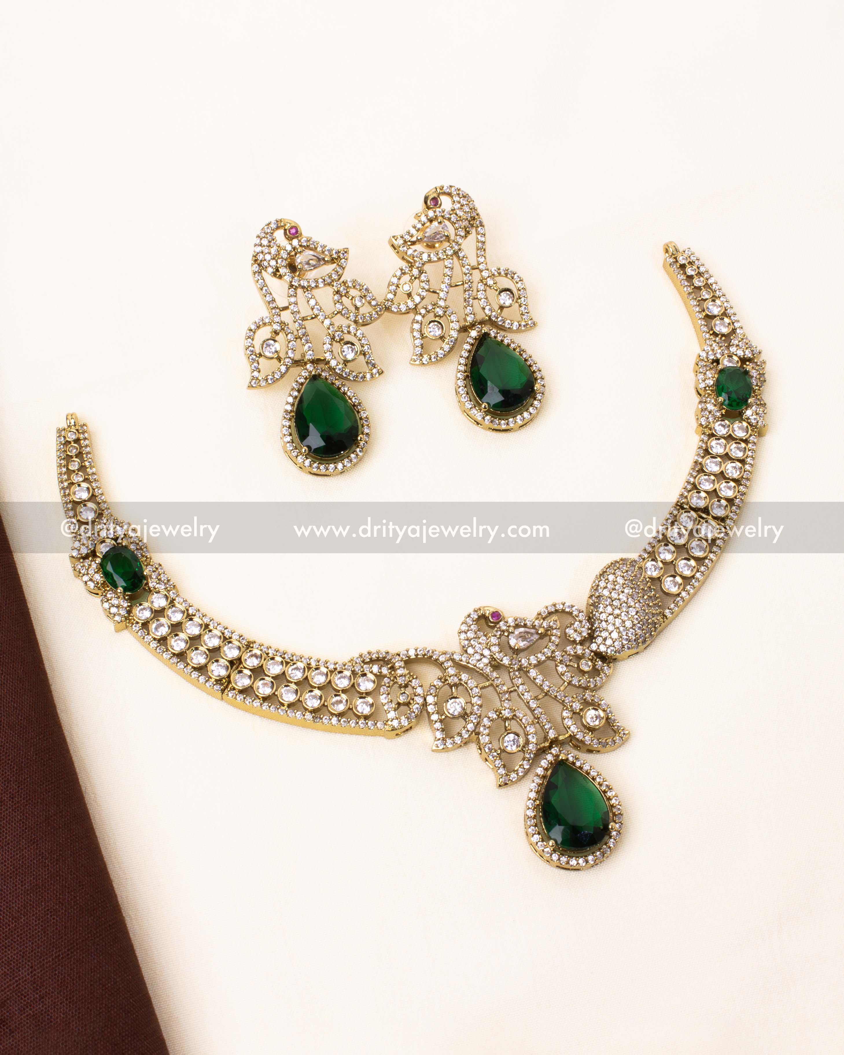 Elegant emerald green Victorian peacock necklace with dazzling white stones.