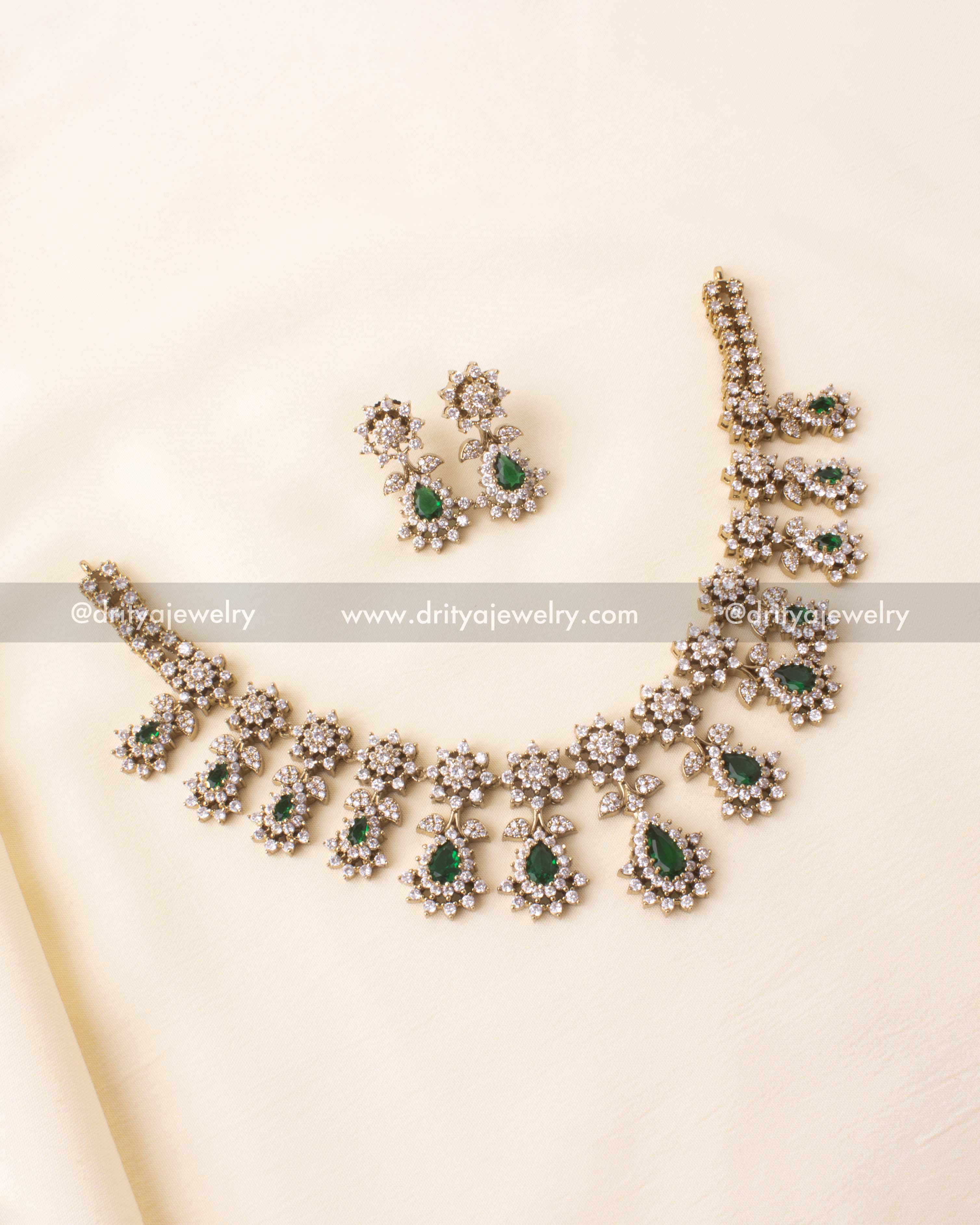 Short necklace with emerald green CZ stones and antique Victorian finish with matching earrings.