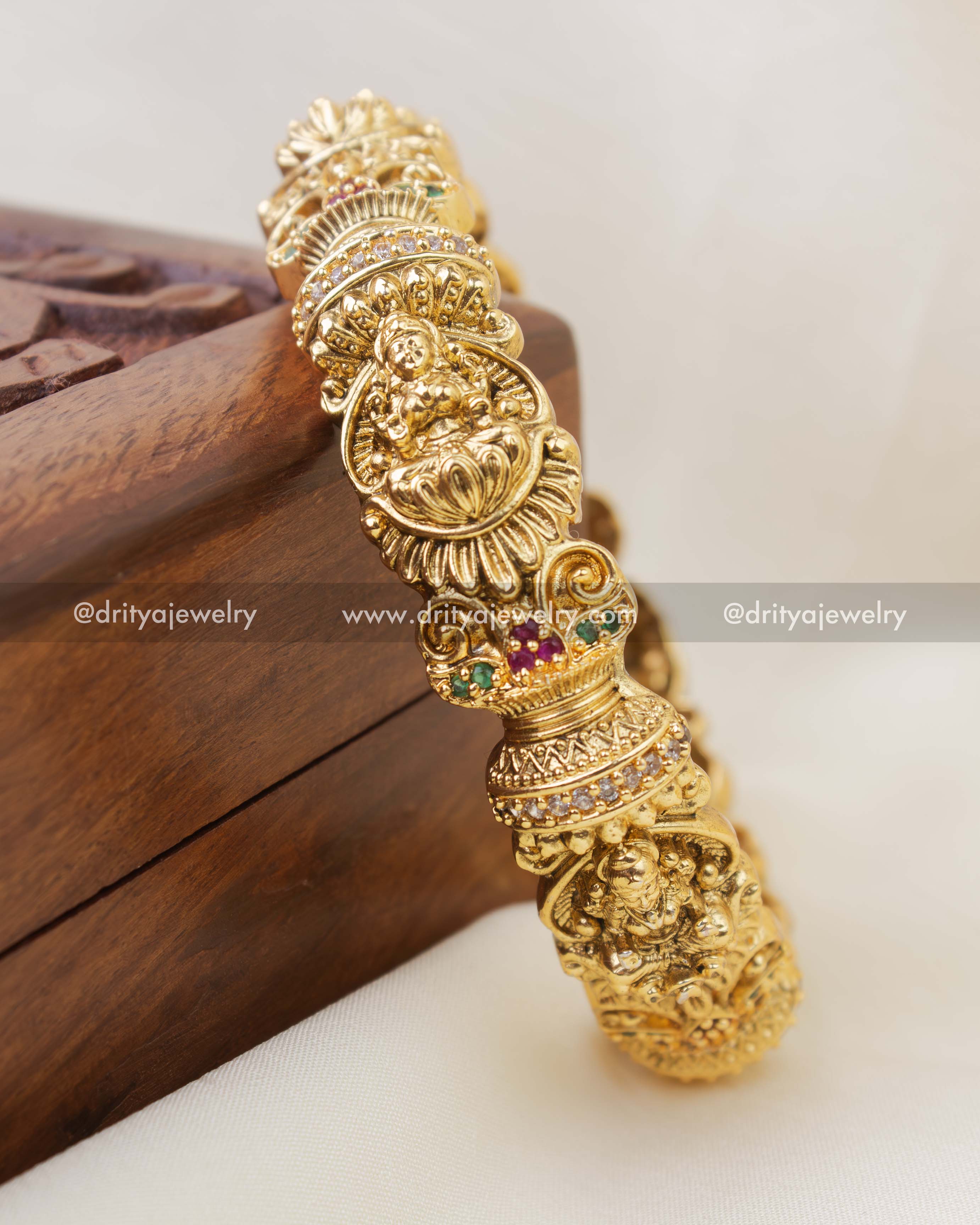 Close-up of nakshi temple bangle with Lakshmi Devi carving and stone accents