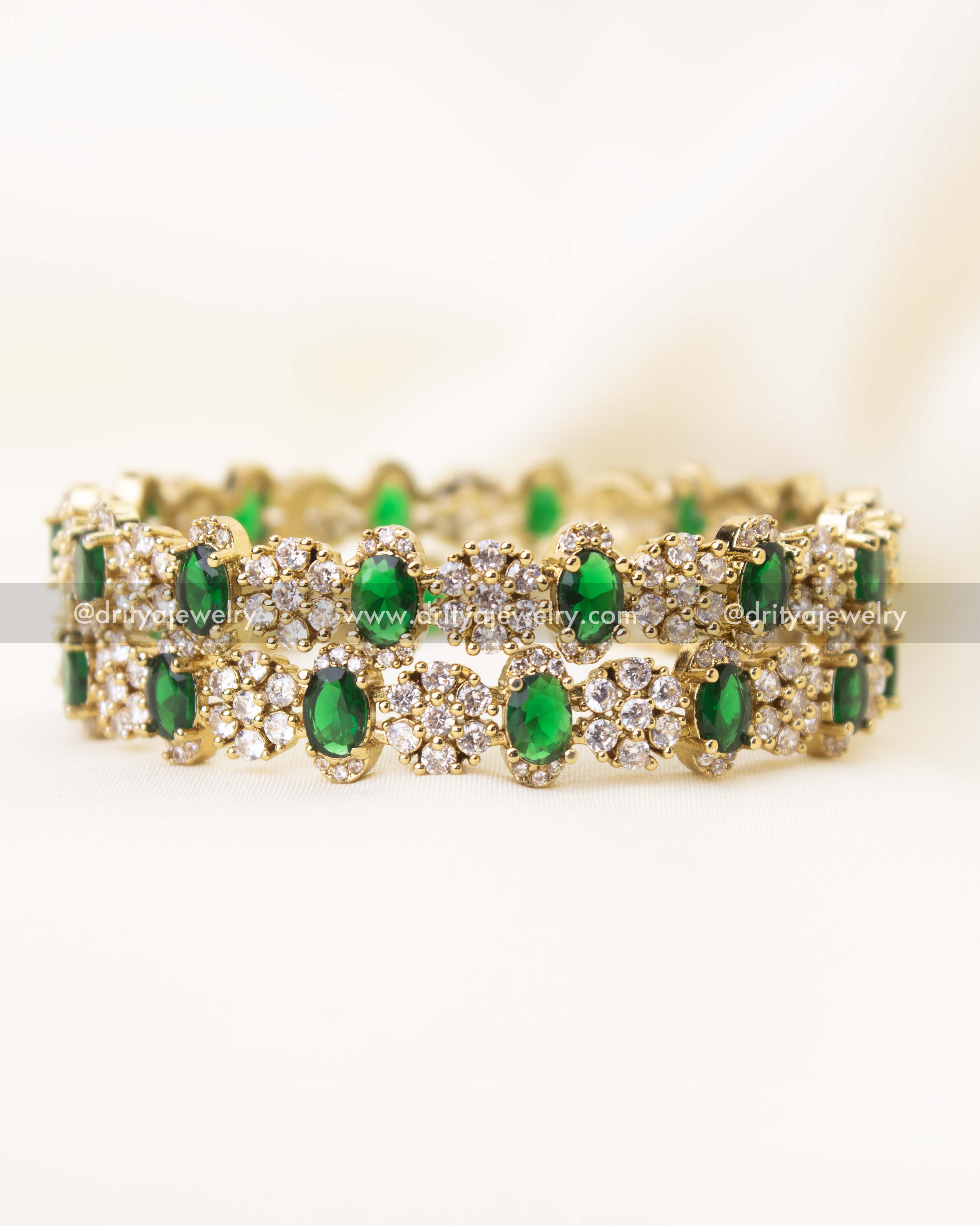 Side angle view of emerald green Victorian polish bangles showcasing detailed craftsmanship