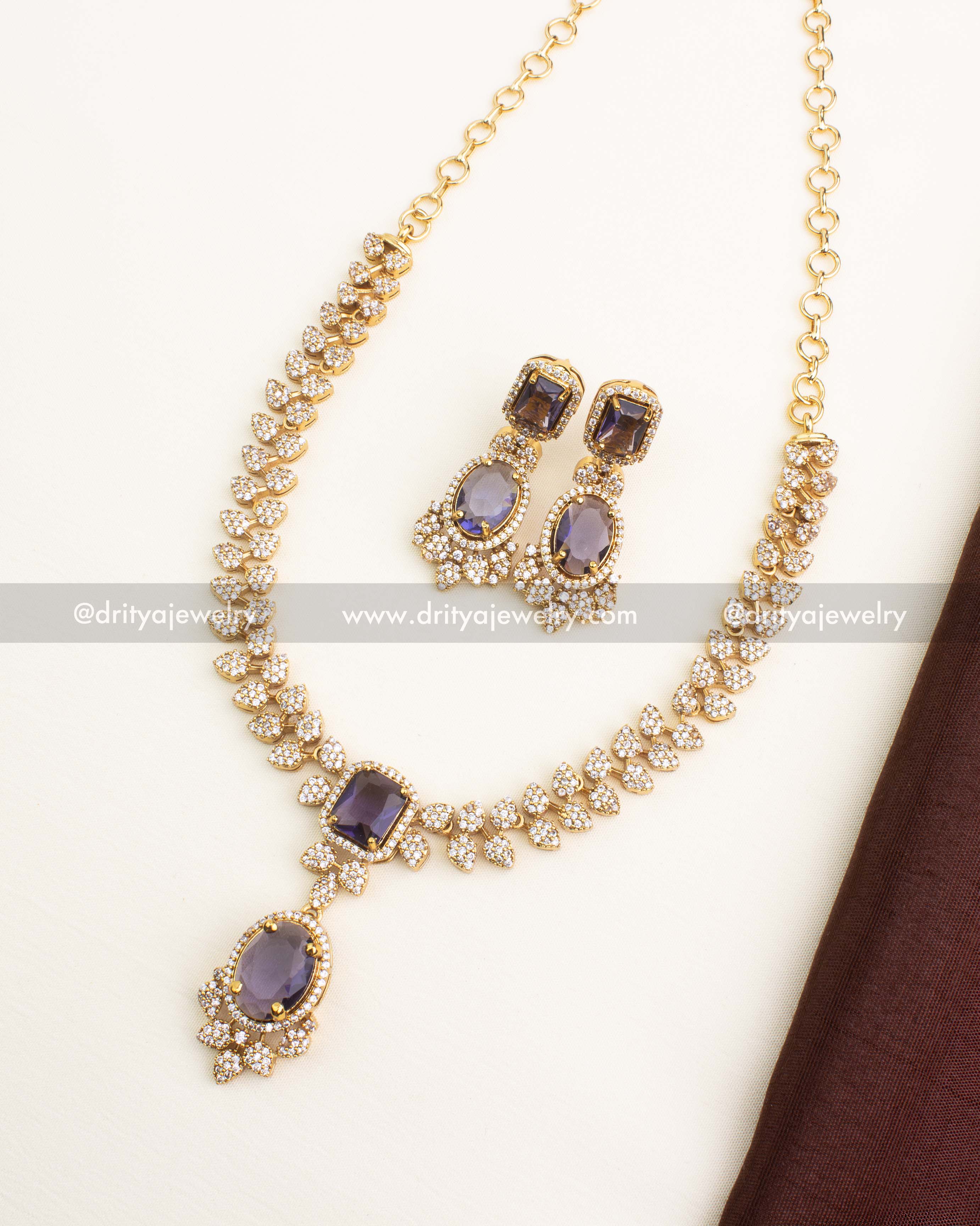 Purple CZ necklace set with amethyst-tone stones and CZ diamonds.