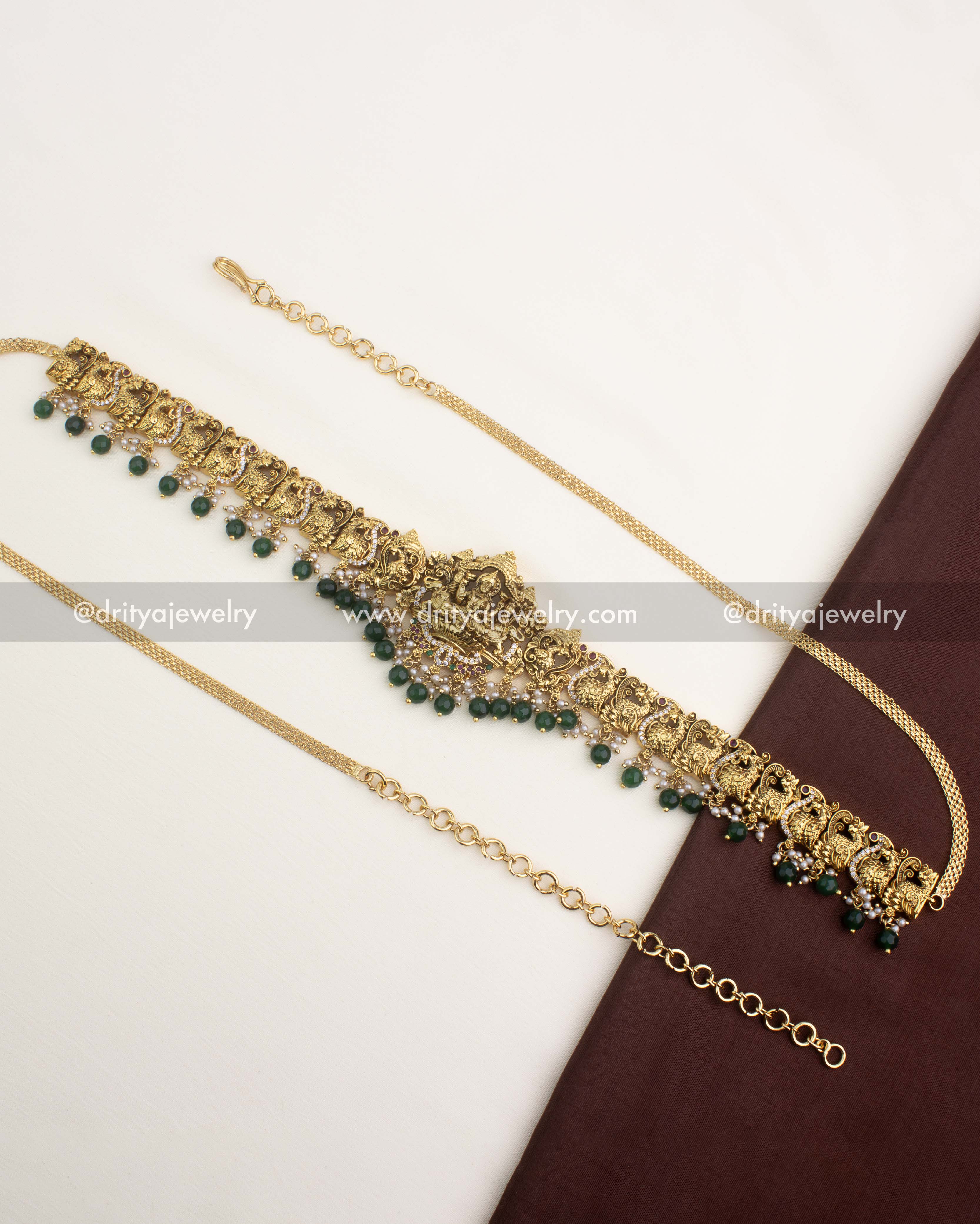Premium gold-plated temple hip chain with Lakshmi motif and emerald green bead hangings.