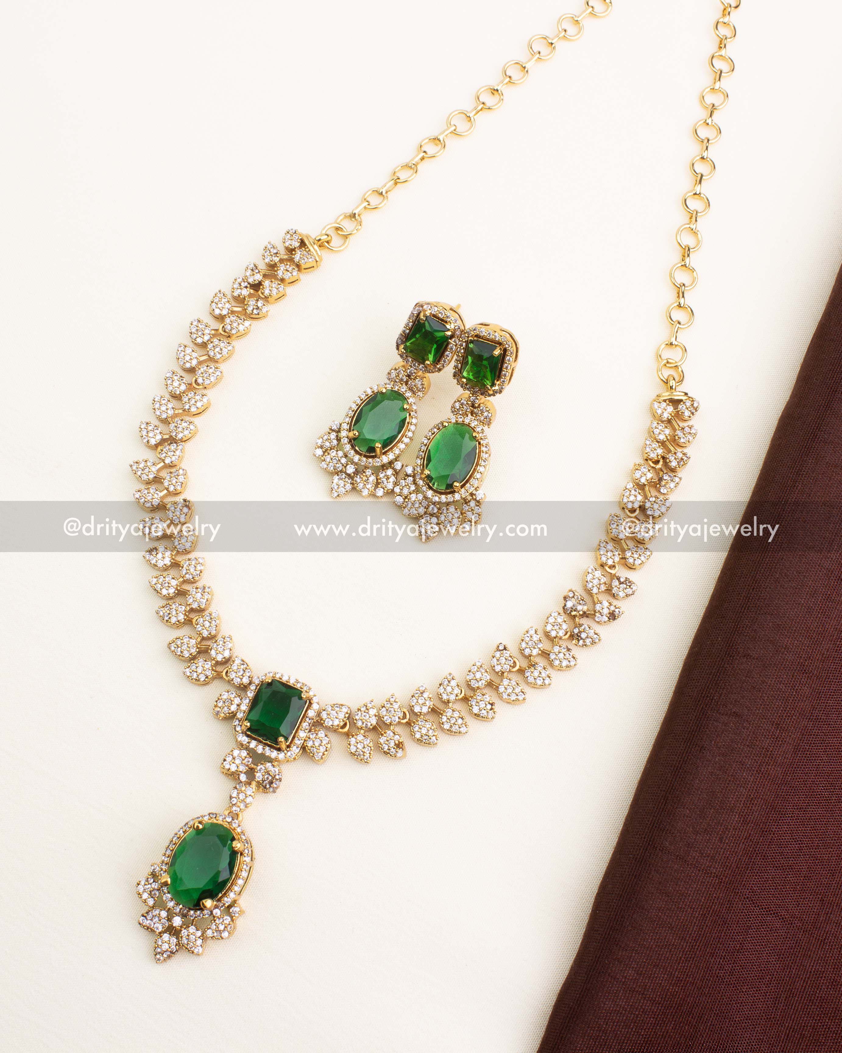 Green CZ short necklace set with emerald stones and matching earrings.
