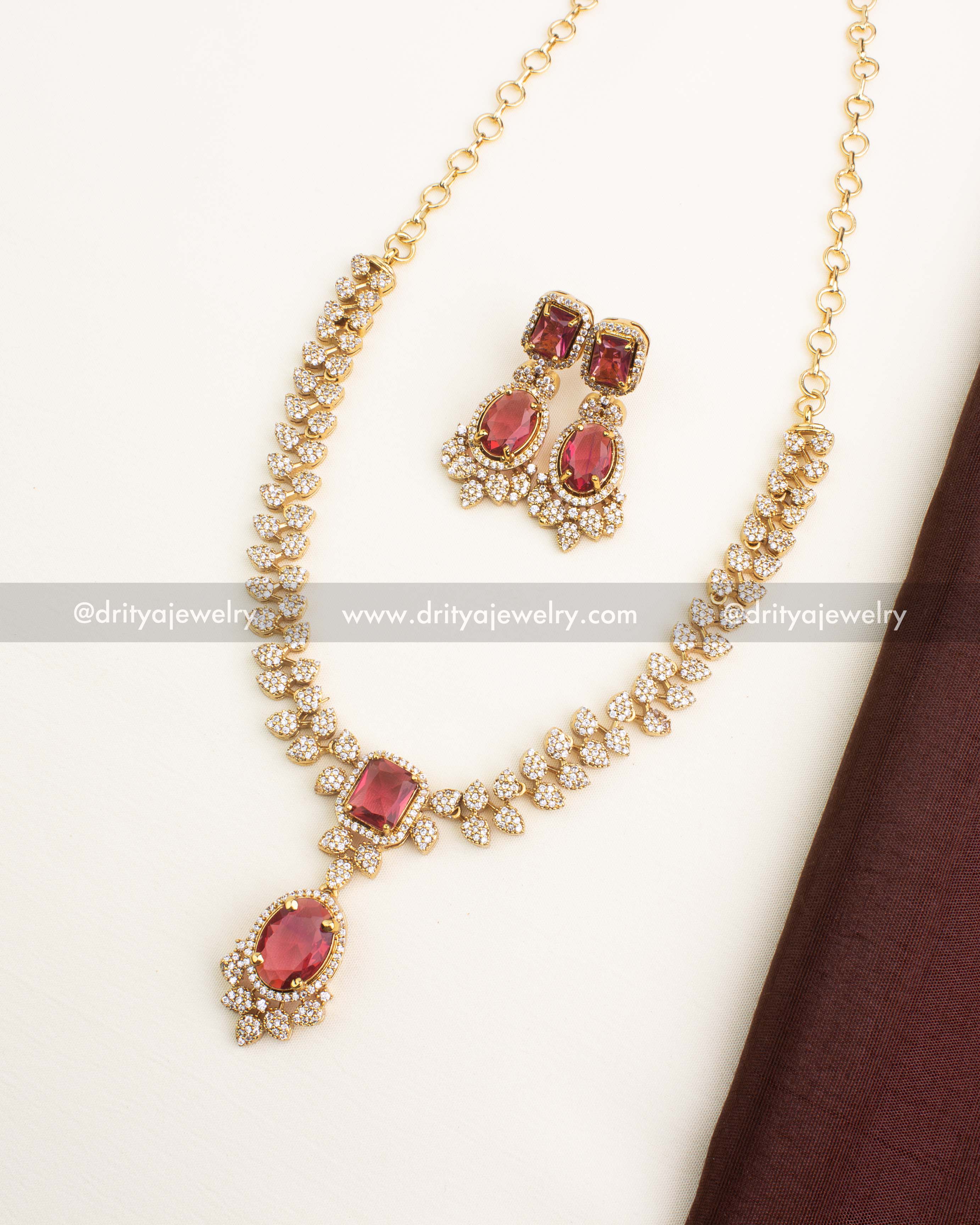 Red CZ short necklace set with ruby-coloured stones and diamond CZ clusters.