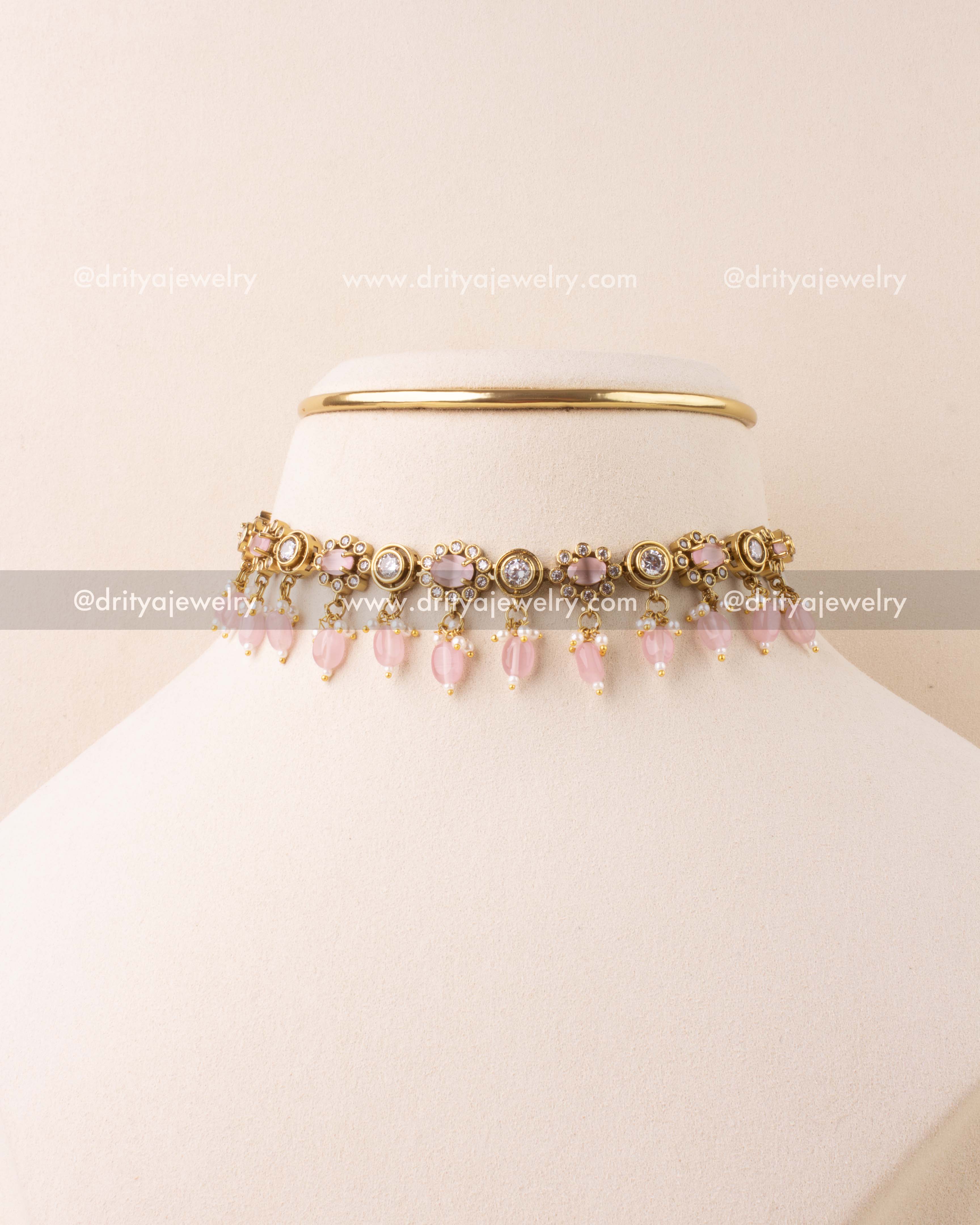 Blush pink choker necklace with AD stones and bead danglers in antique gold finish.