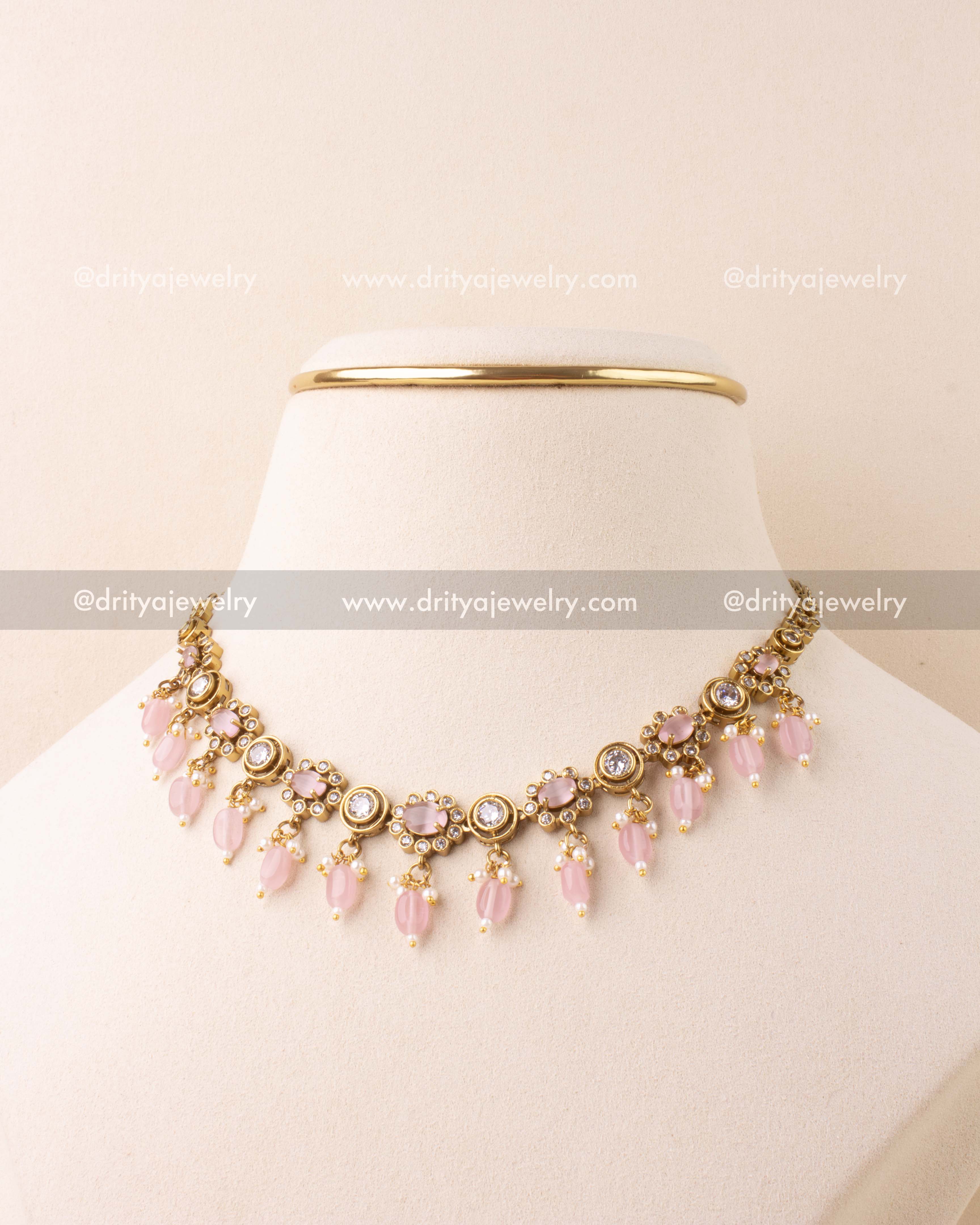 Blush pink choker necklace with AD stones and bead danglers in antique gold finish.