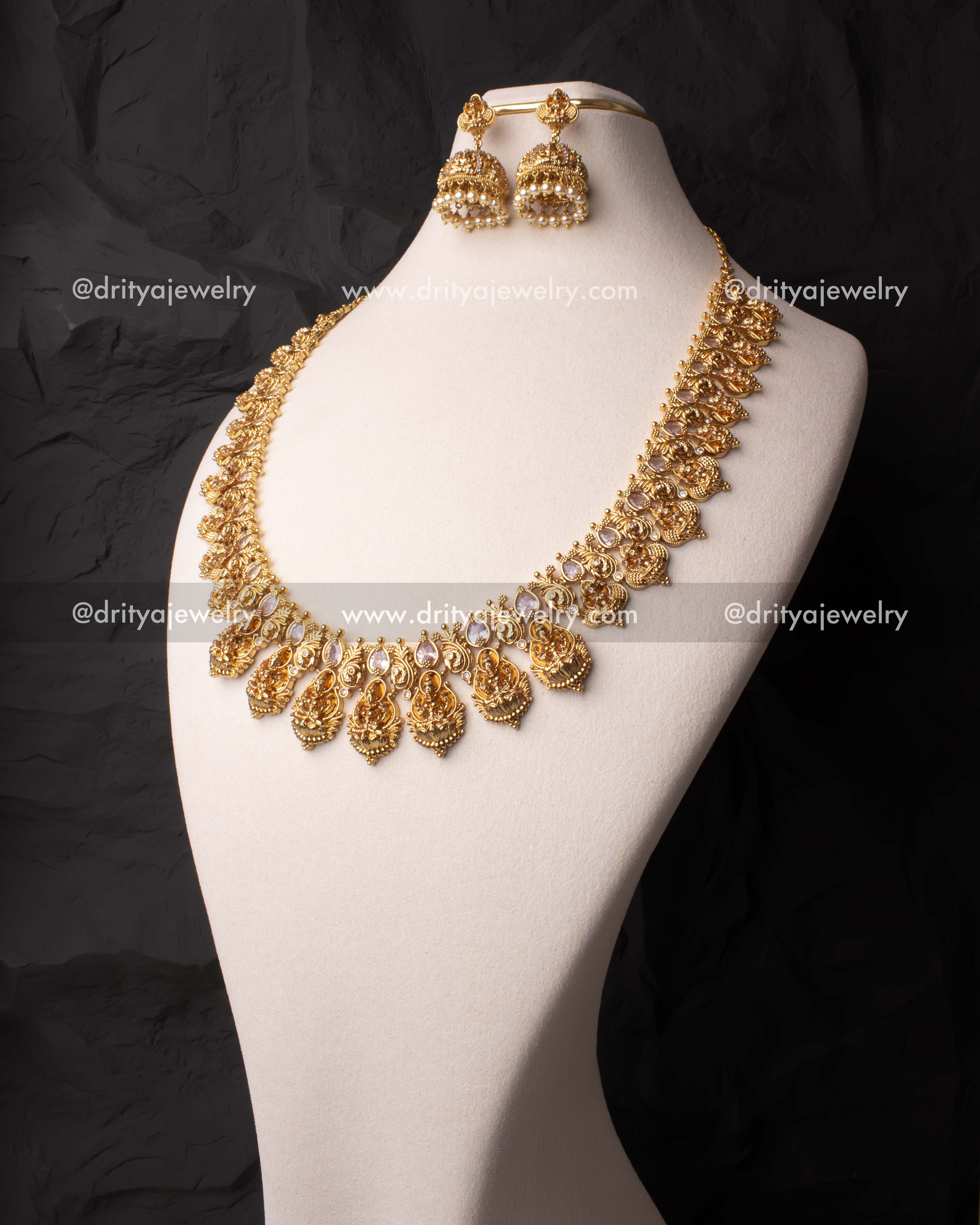 Elegant long haram set with white CZ stones and temple motifs, paired with matching jhumkas.