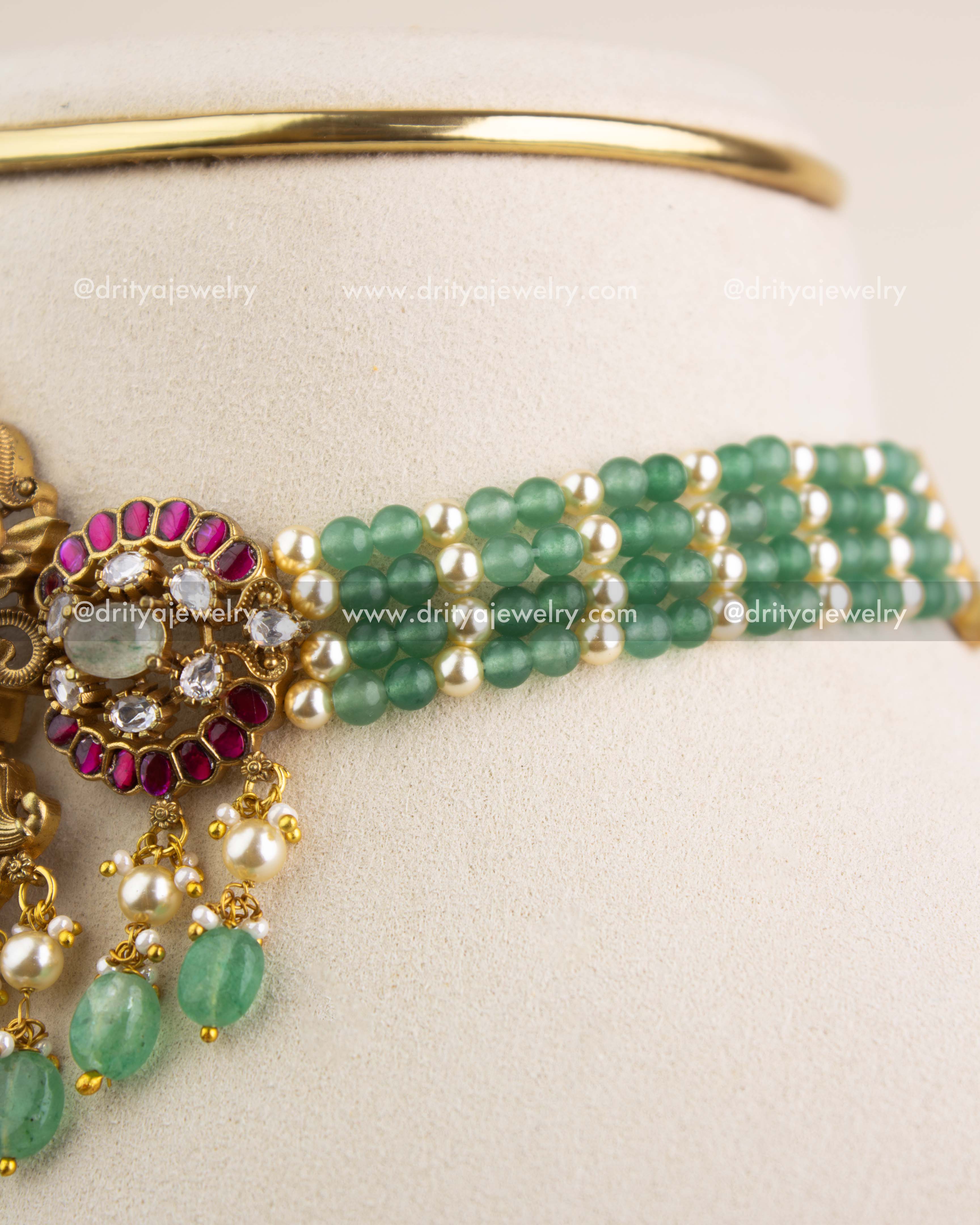 Close-up of multi-layer green beads and pearls on Lakshmi Devi temple choker.