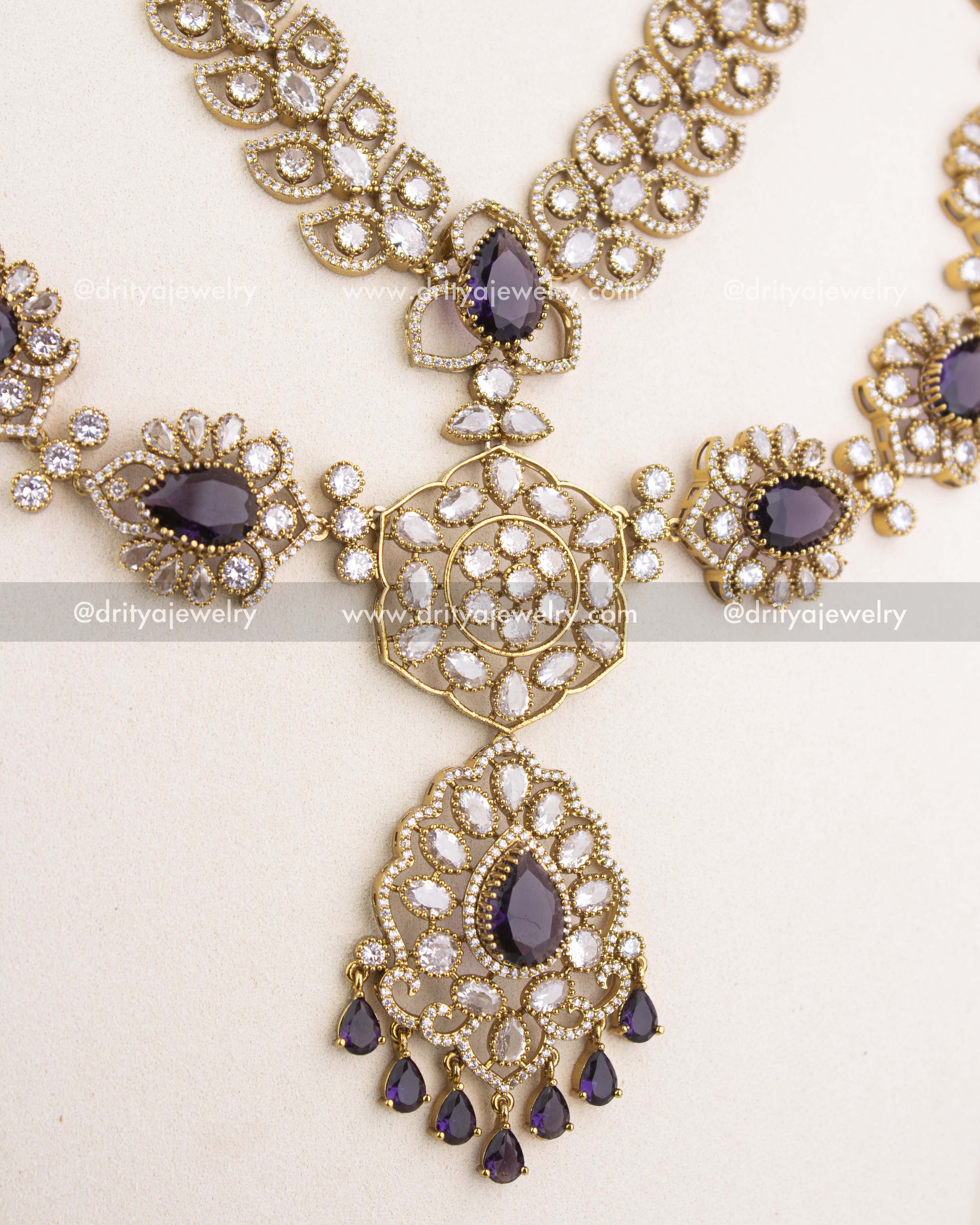 Center pendant of purple Victorian bridal necklace featuring teardrop stones, floral workmanship, and pearl-inspired drops.